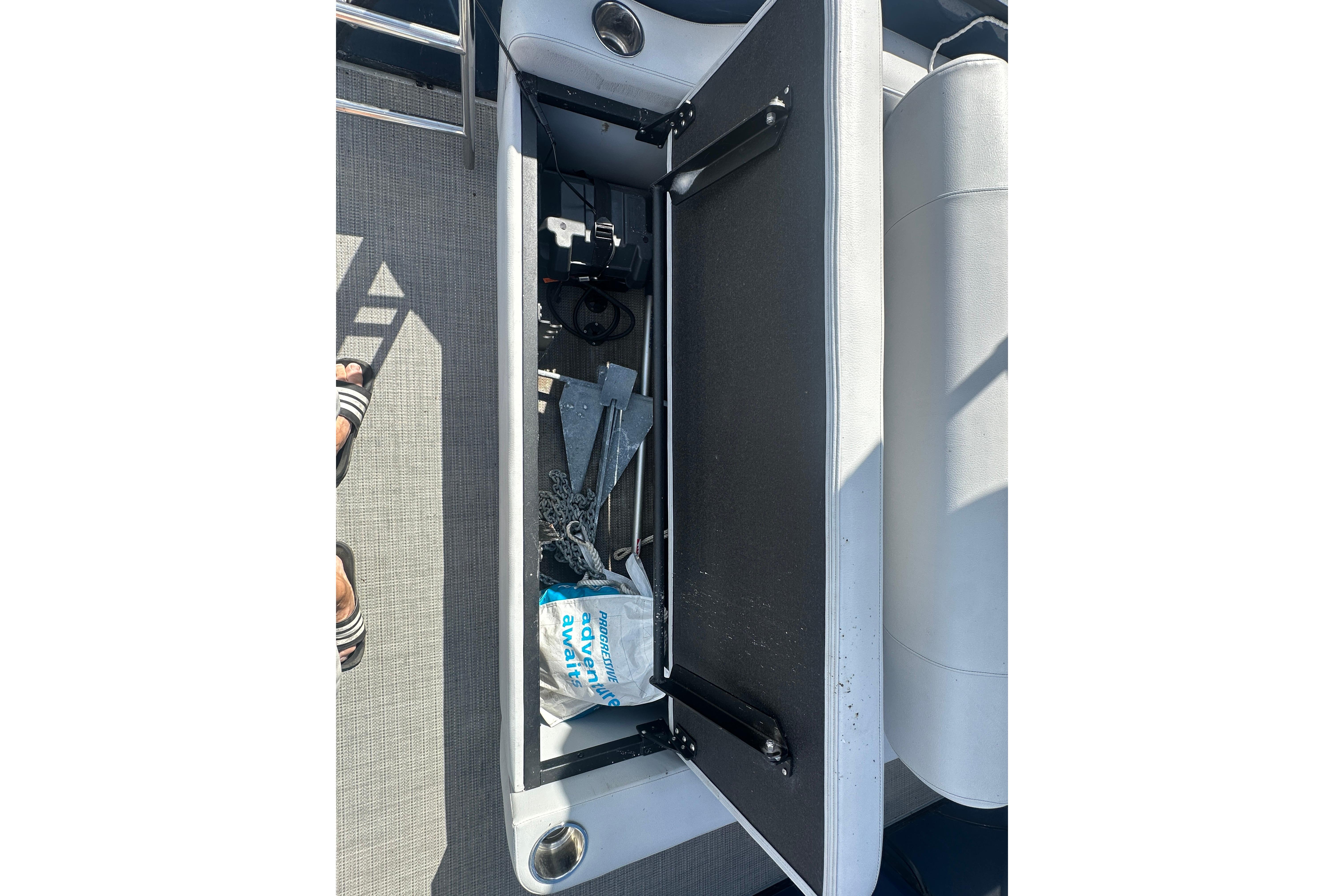 2023 Bentley Pontoons Legacy 243 Swingback storage compartment with anchor and accessories.