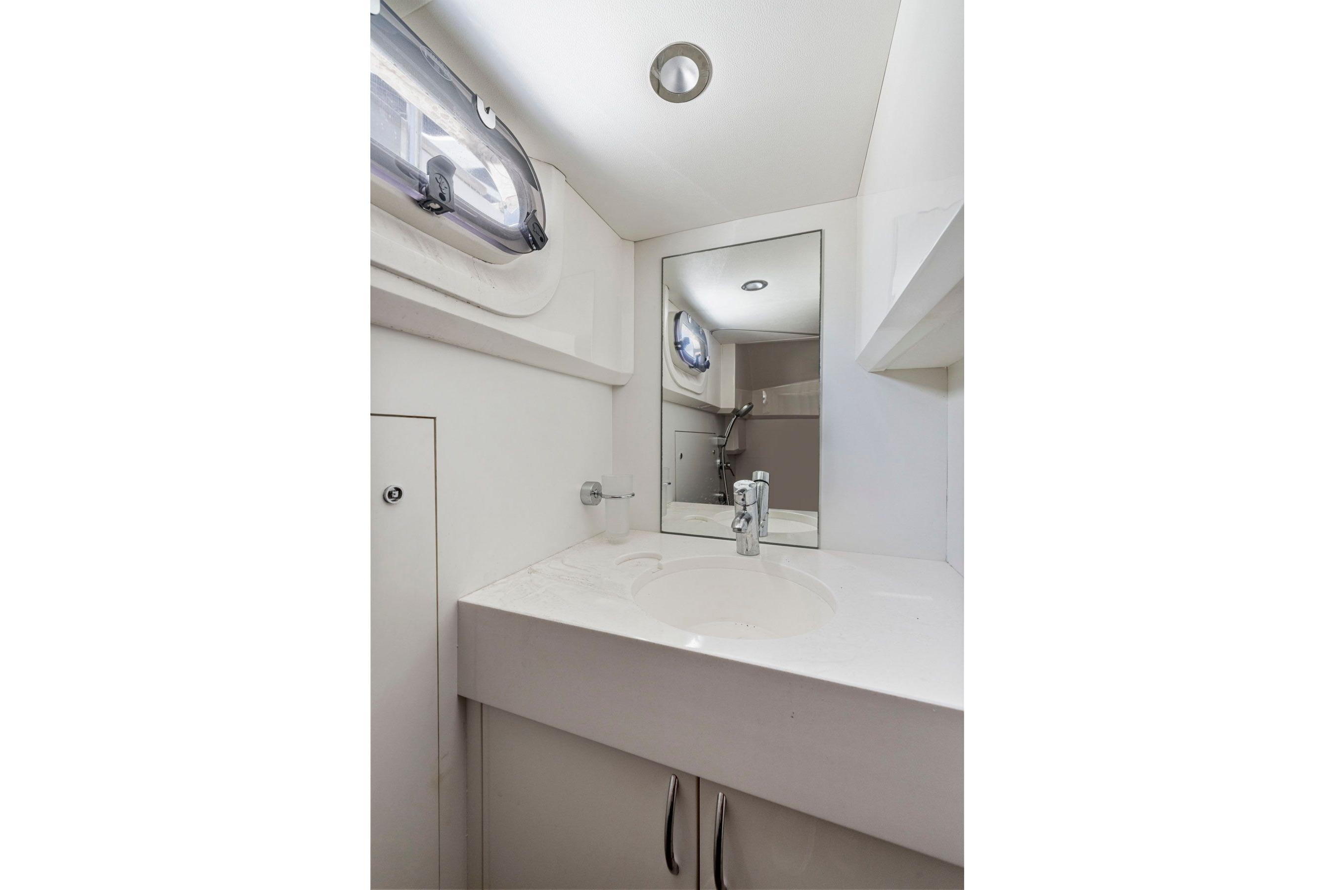 Bathroom interior of 2015 Princess 60 Flybridge Motor Yacht, featuring modern sink and mirror.