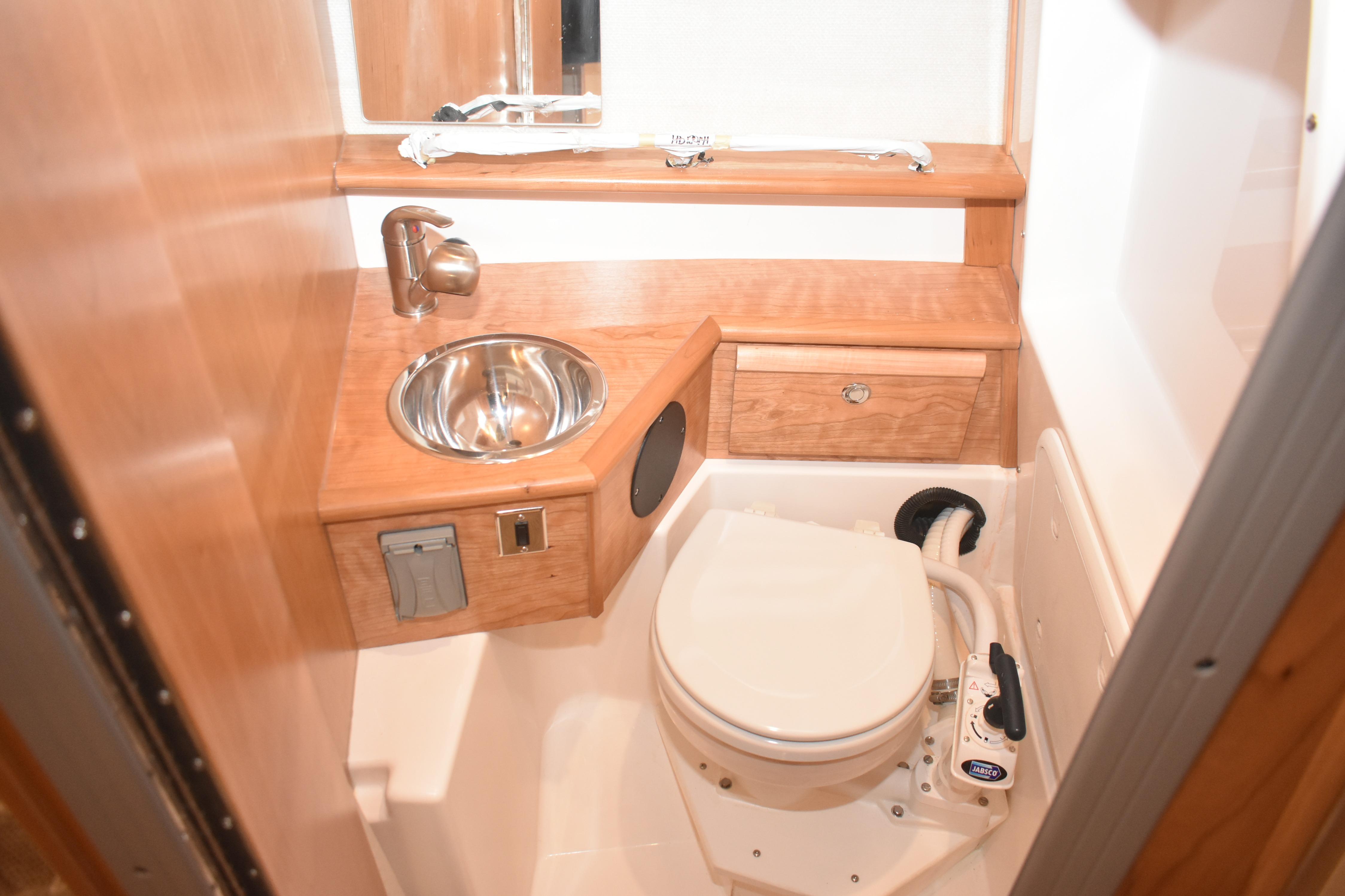 Compact bathroom in 2026 Cutwater C-248 Coupe with sink and toilet.