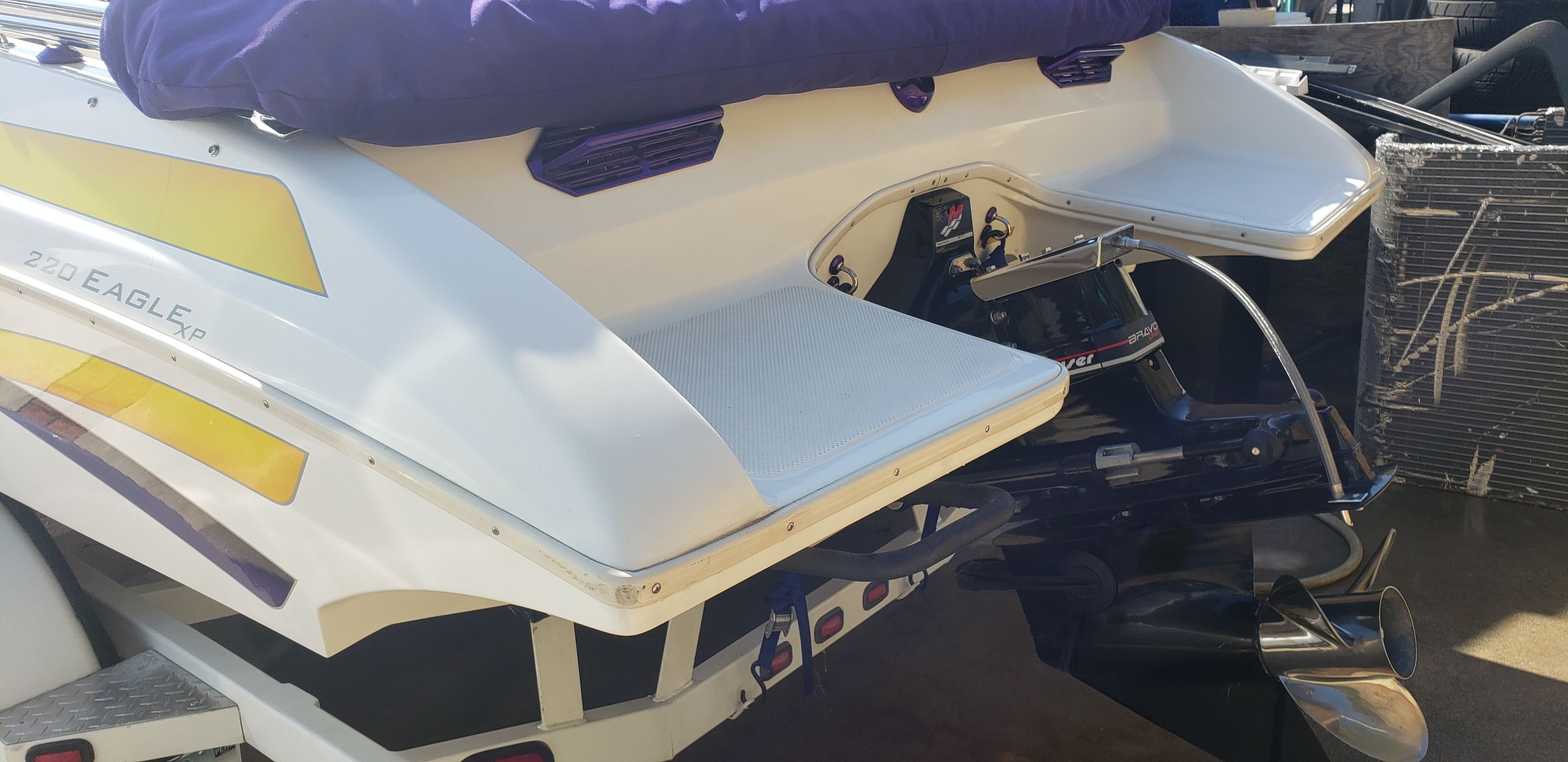 Rear view of a 1999 Eliminator 220 Eagle XP boat with engine.