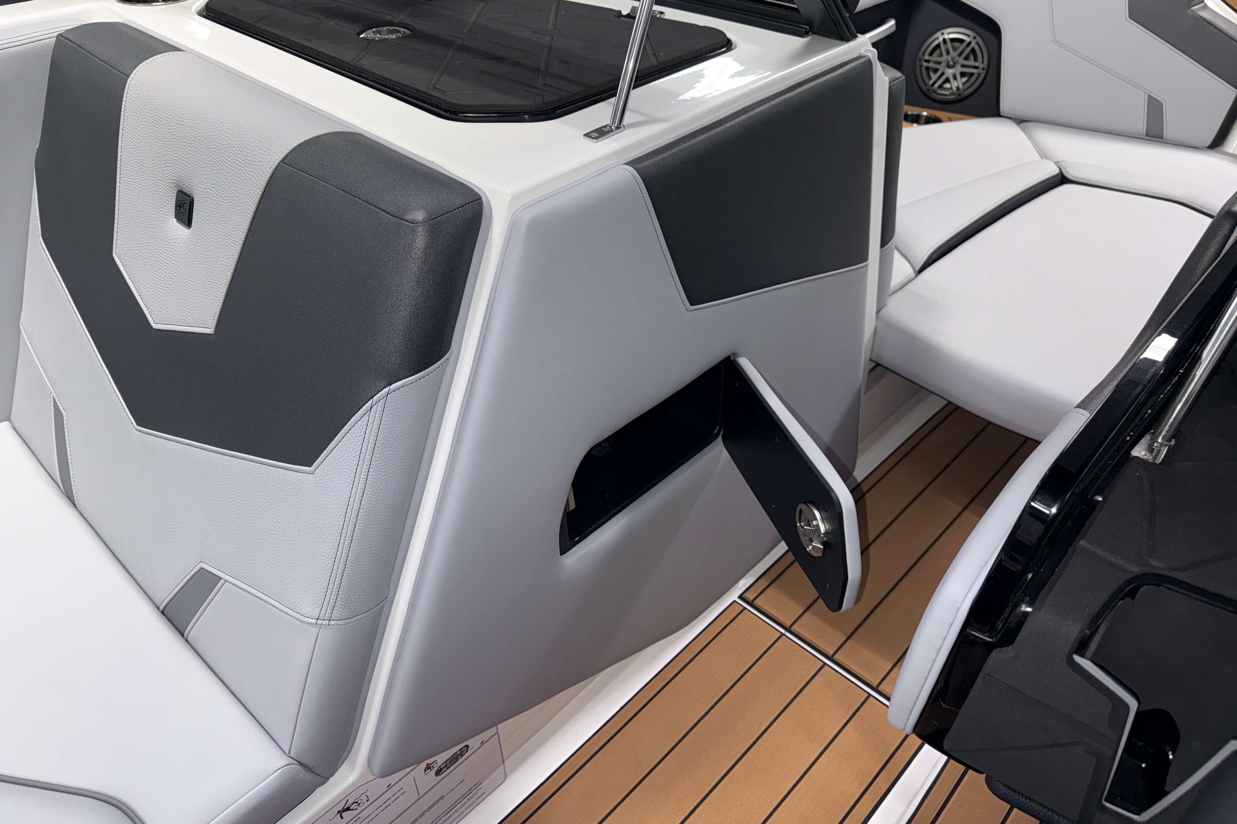 2026 Nautique Super Air Nautique GS22 interior with sleek seating and storage compartment.