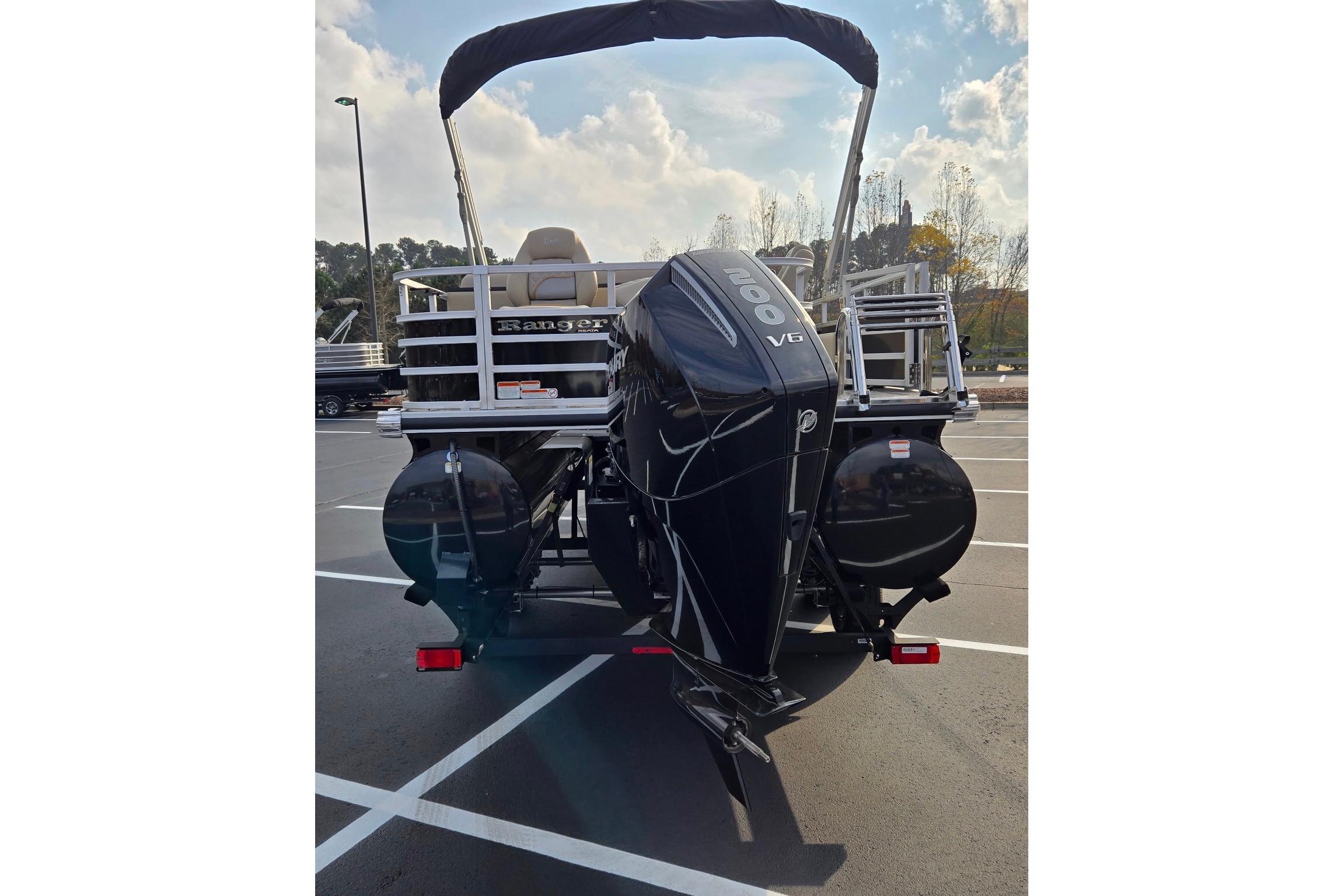 2025 Ranger Reata 223FC boat with powerful V6 engine in parking lot.