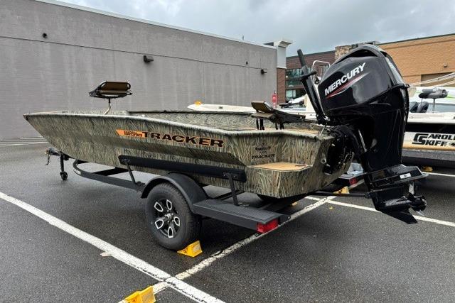2026 Tracker Grizzly 1756 T Marsh boat with Mercury engine on trailer in parking lot.