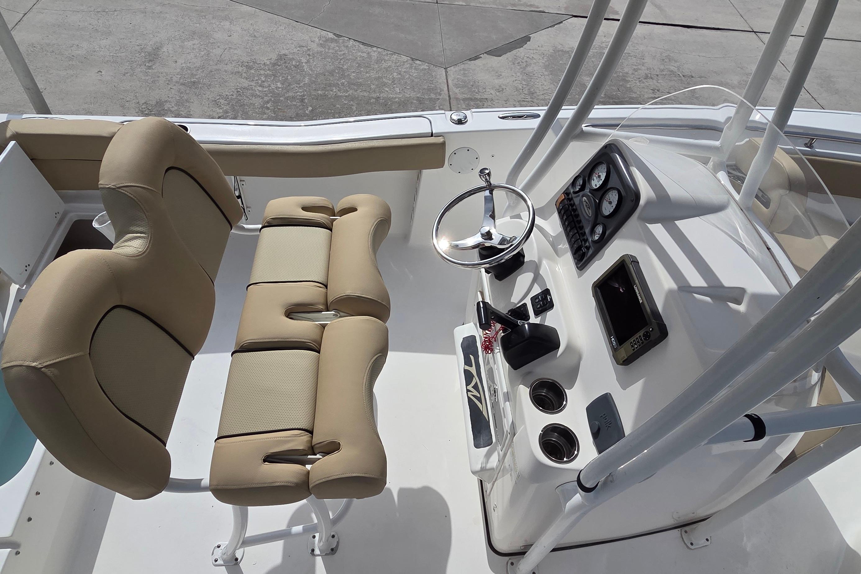 2015 Tidewater 220 LXF boat interior with dual seats and steering console.
