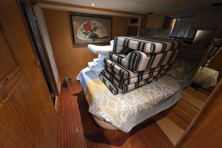 Interior of 1993 McKinna 48 Pilothouse with stacked cushions on bed.