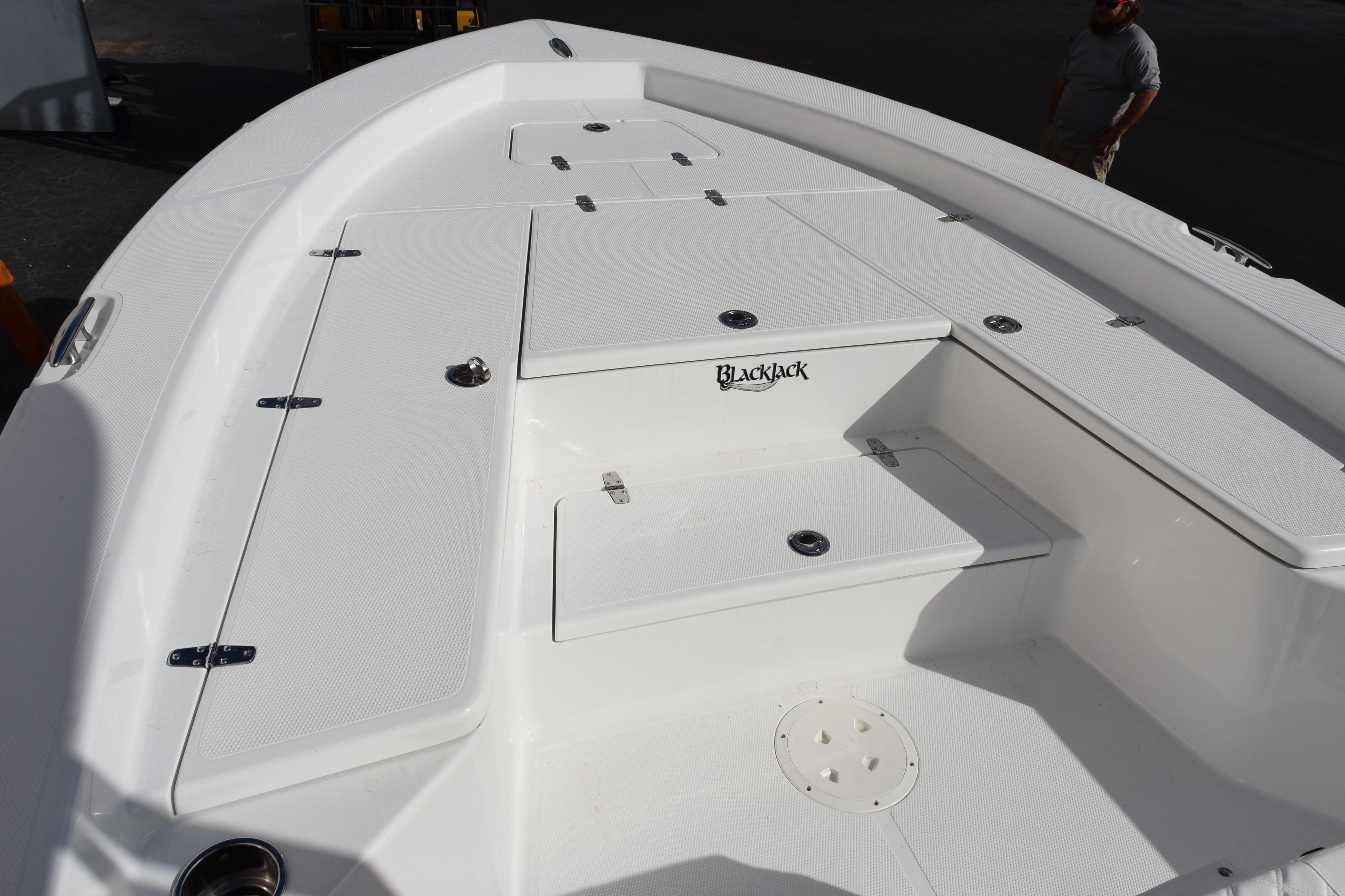 2026 BlackJack 256 Bay boat deck with storage compartments.