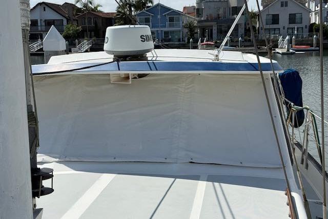 1982 Lancer 45 Motorsailer docked, featuring a covered deck and radar equipment.
