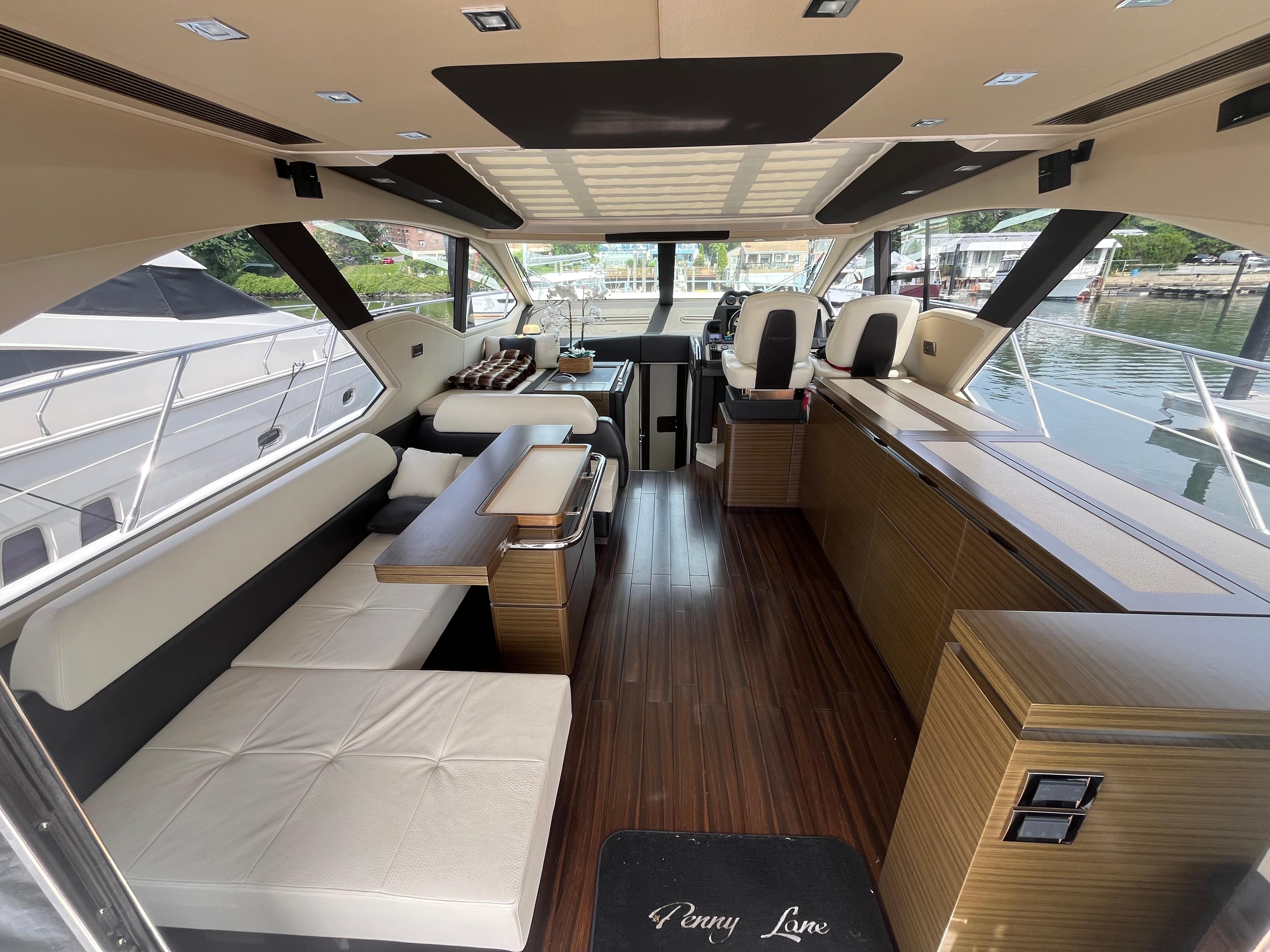 Luxurious interior of a 2014 Azimut 55S yacht with elegant seating and modern design.