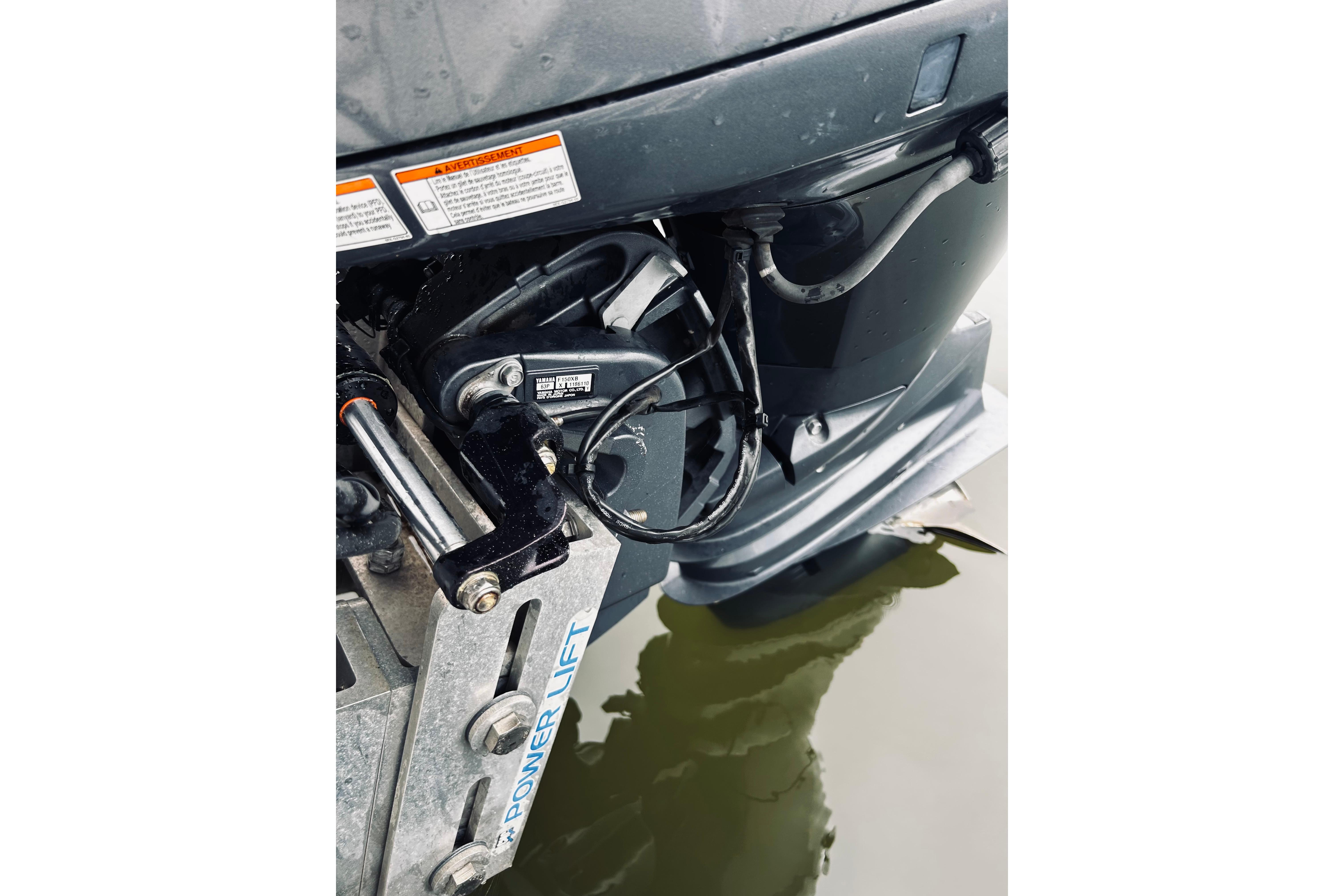 Close-up of a 2017 Blue Wave 2200 PureBay boat motor and power lift system.