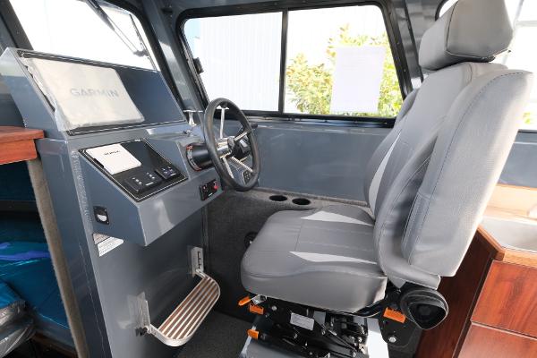 2024 Hewescraft 250 Explorer interior with steering wheel and captain's chair.