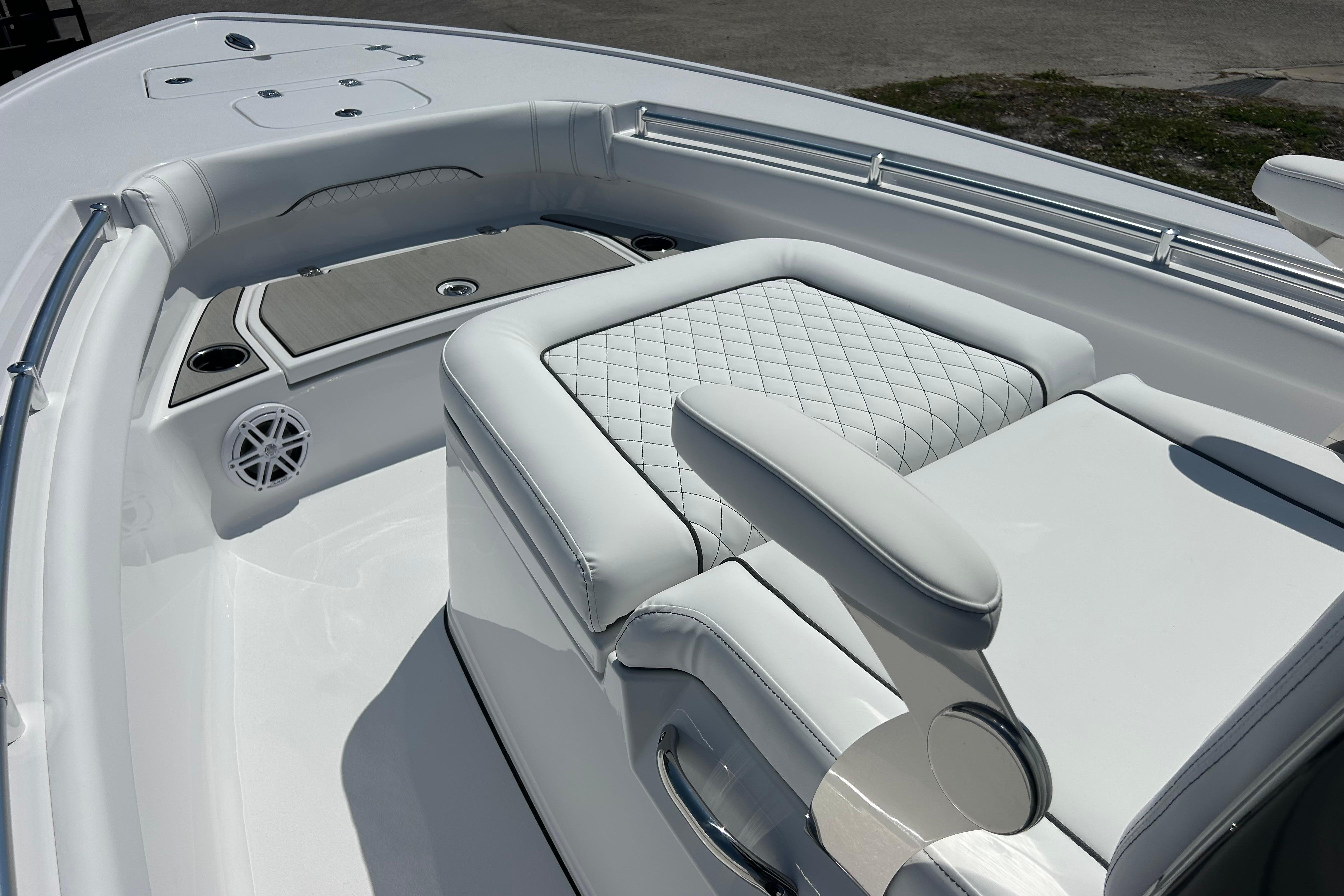2026 Sportsman Masters 247OE Bay Boat interior with white quilted seating and cup holders.