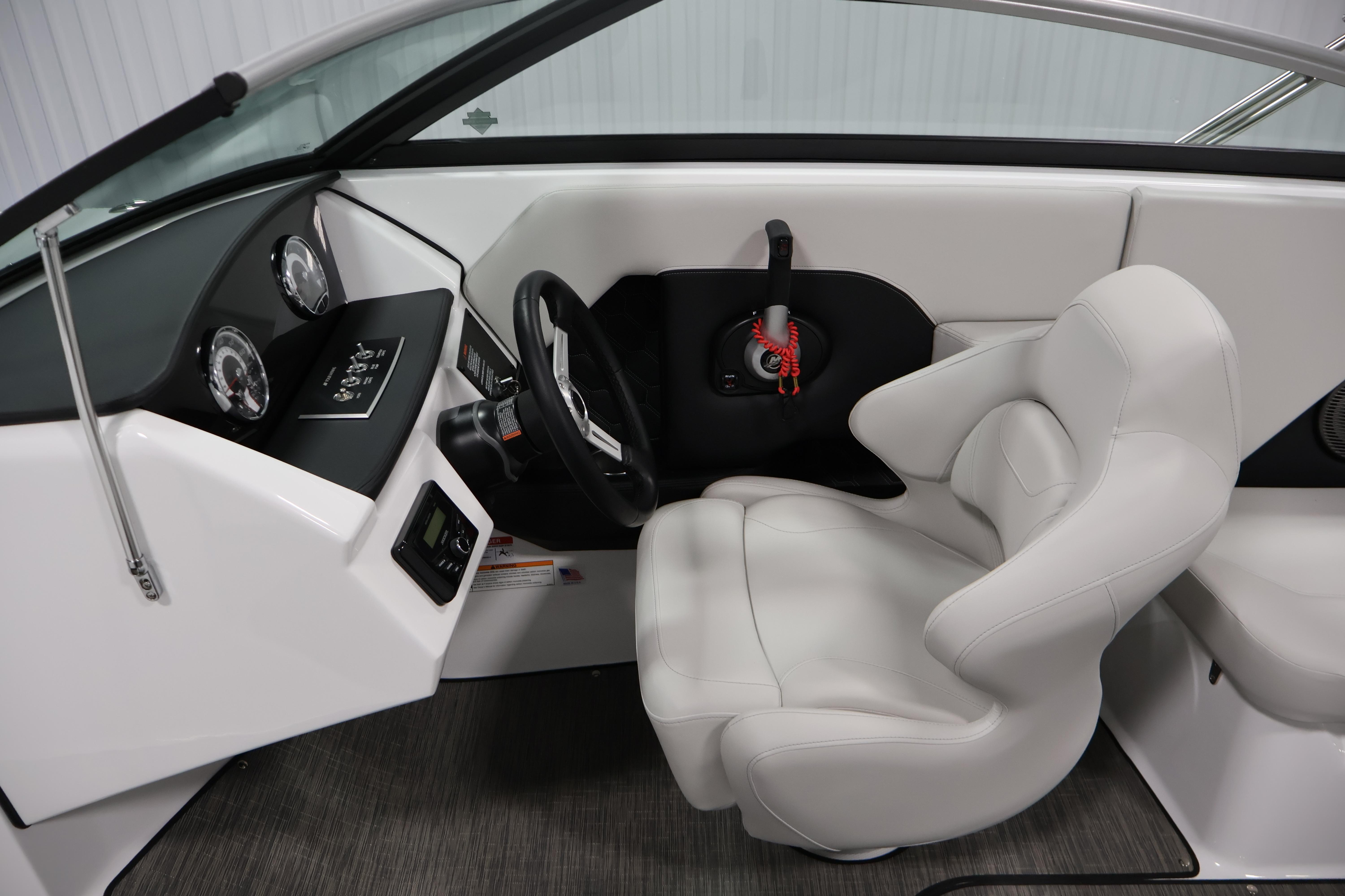 2026 Four Winns H4 Freedom boat interior with modern dashboard and plush captain's seat.