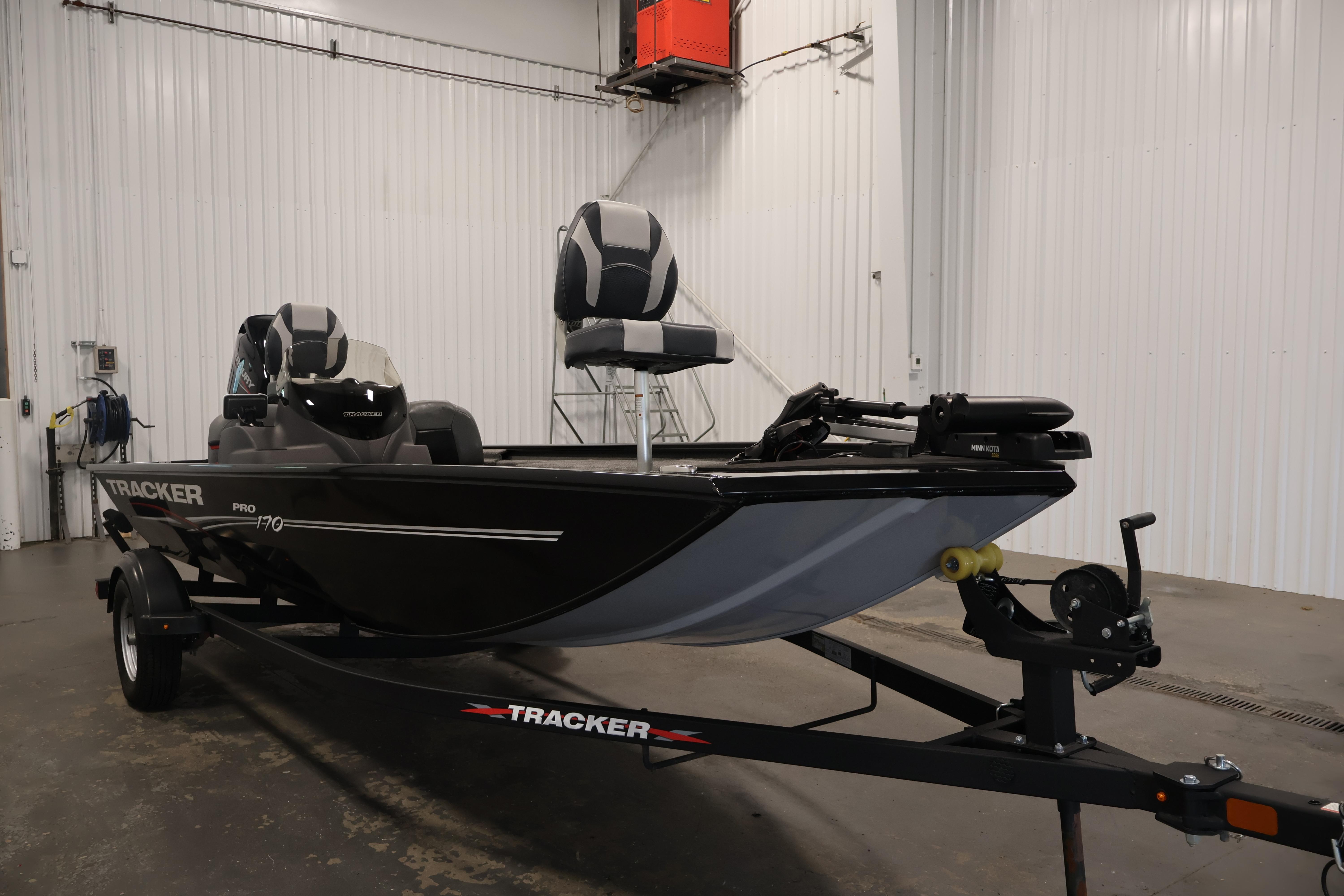 2024 Tracker Pro 170 boat in a garage, featuring sleek design and modern seating.