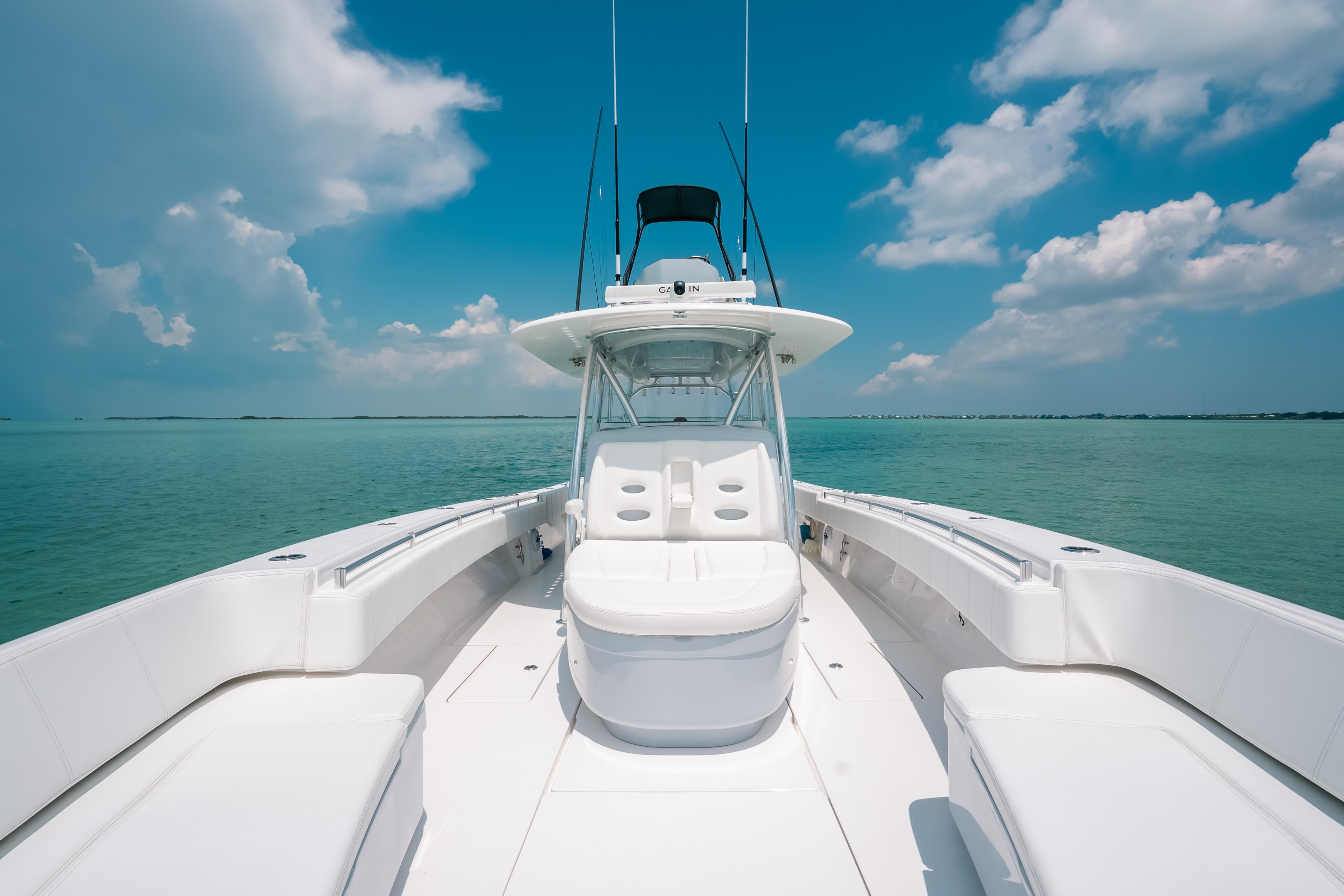 2025 Contender 44 ST boat on calm ocean under blue sky.