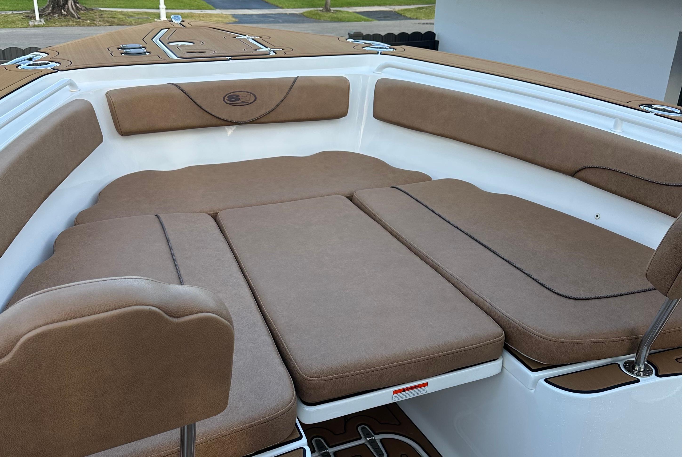 2019 Sea Hunt Gamefish 25 boat interior with brown cushioned seating.