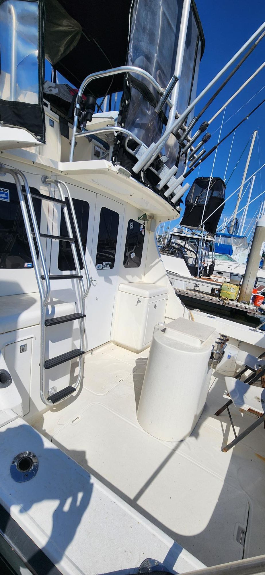 1990 Luhrs 320 boat docked in marina under blue sky.