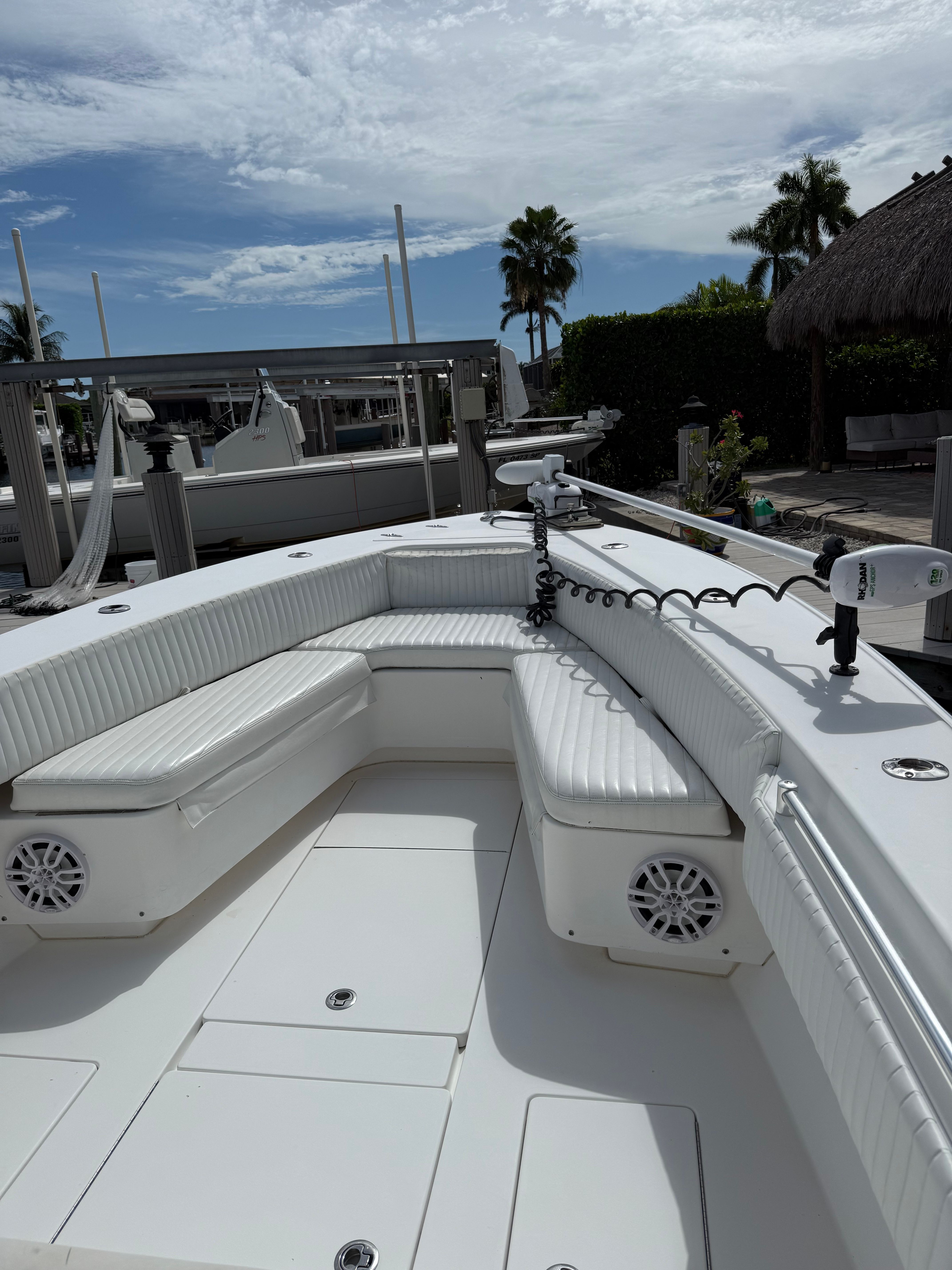 2012 Contender 32 ST boat with white seating area in harbor.