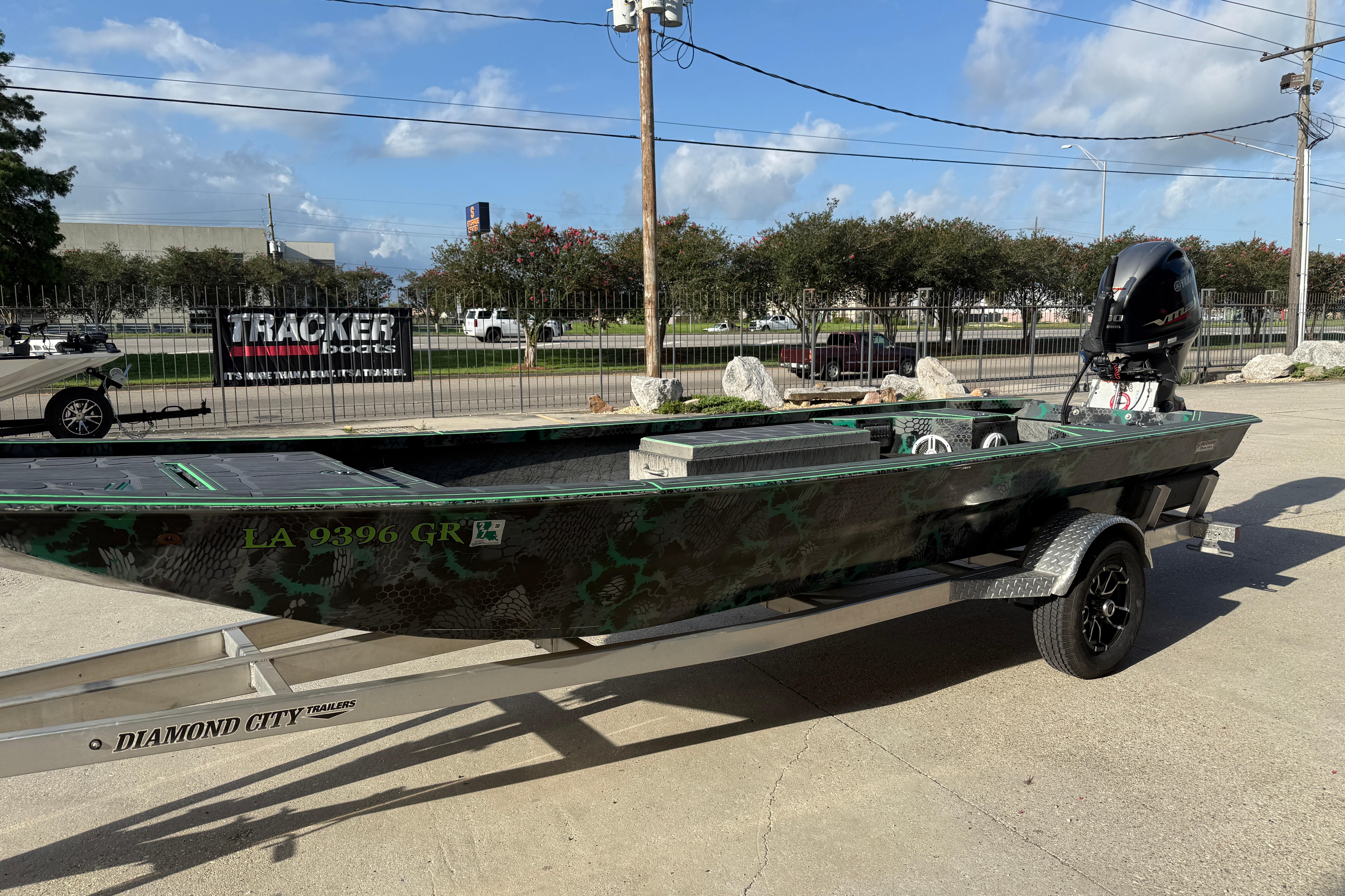 Custom Rene Gros 20x48 boat on trailer, 2024 model, parked outdoors.