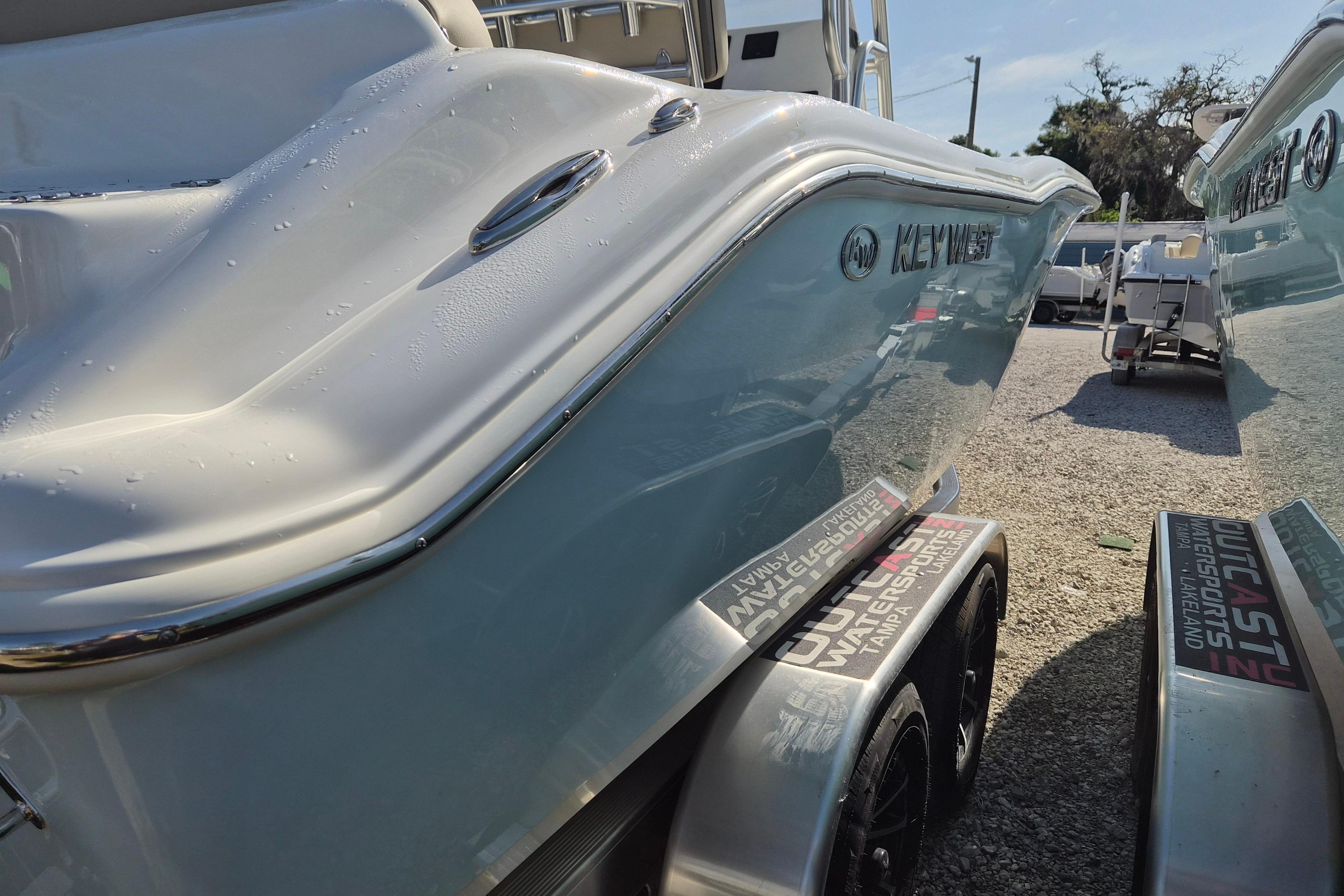2026 Key West 239 FS boat on trailer, side view with sunlight reflections.