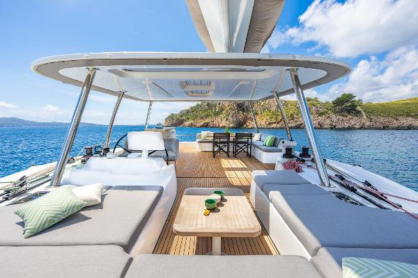 Luxurious Lagoon 60 yacht deck, 2025 model, with elegant seating and ocean view.