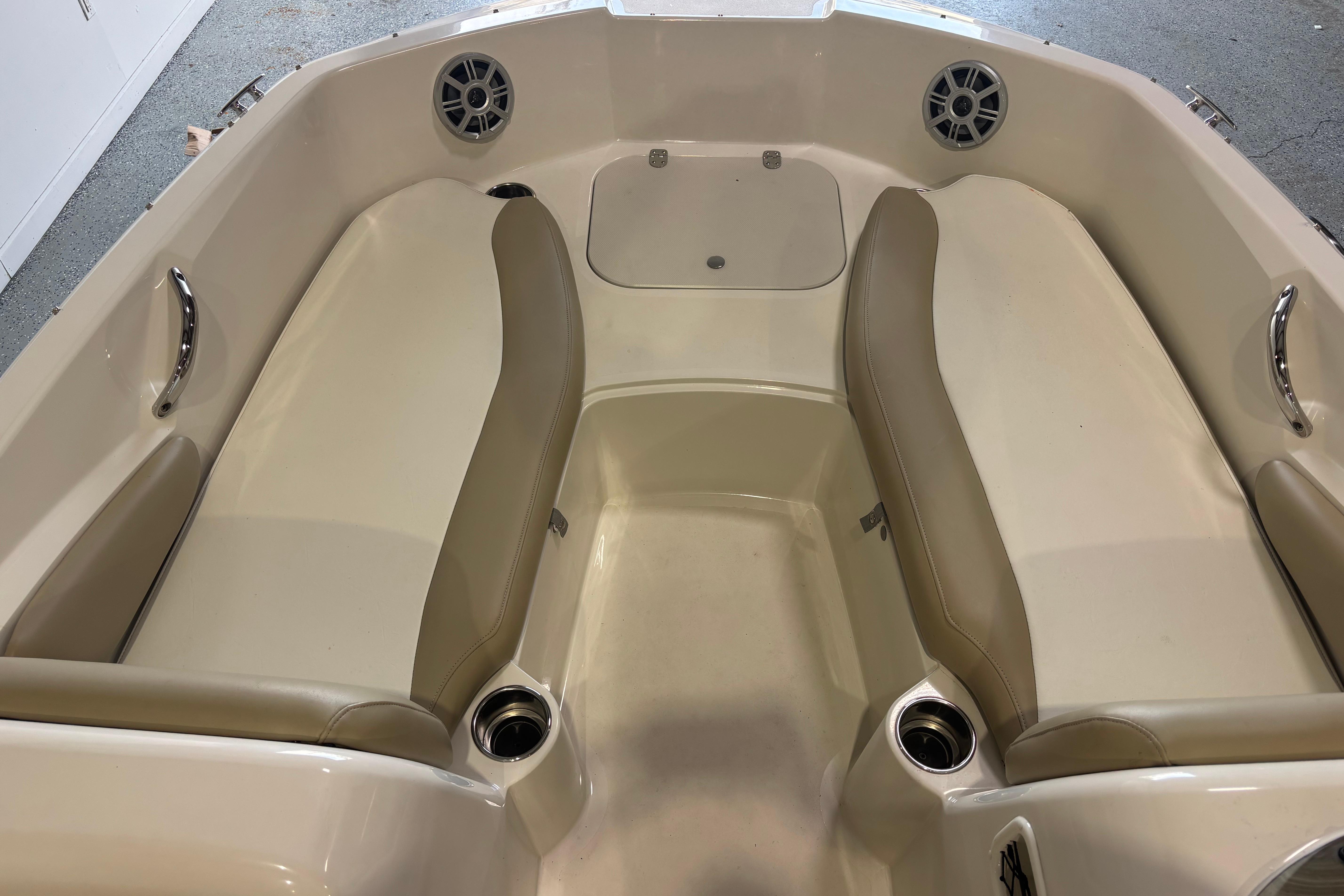 2017 Stingray 182 SC boat interior with beige seating and cup holders.