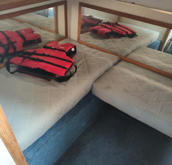 Interior cabin of 1988 Sea Ray 268 DA with life jackets on bed.