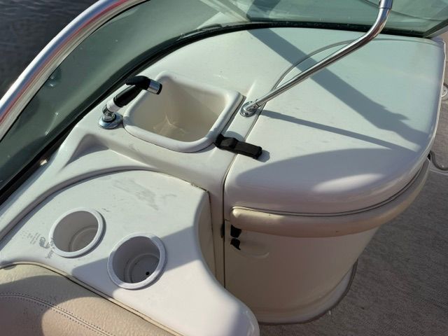 Close-up of a 2001 Sea Ray 210 Sundeck cockpit with cup holders.