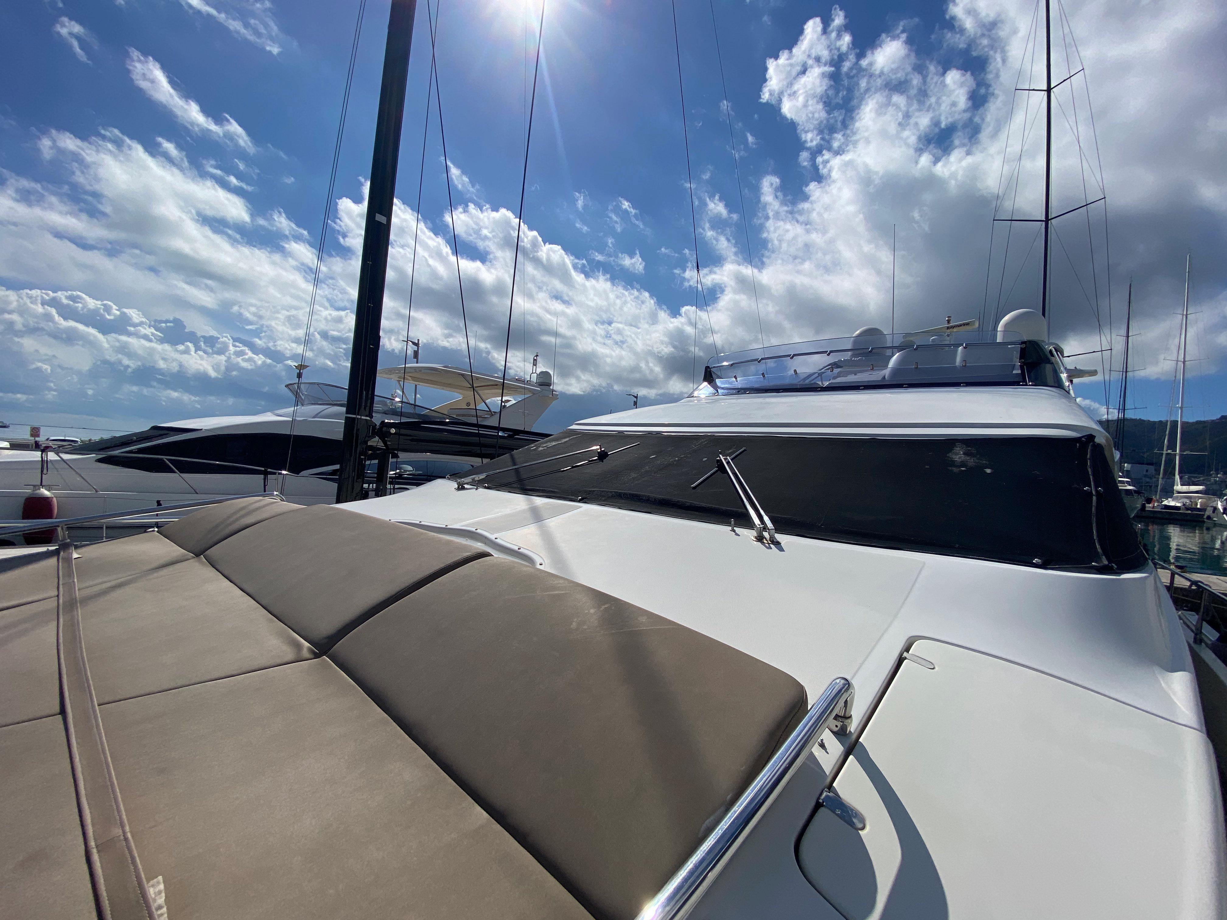 Luxury yacht Dominator 680, 2008 model, docked under a bright blue sky.