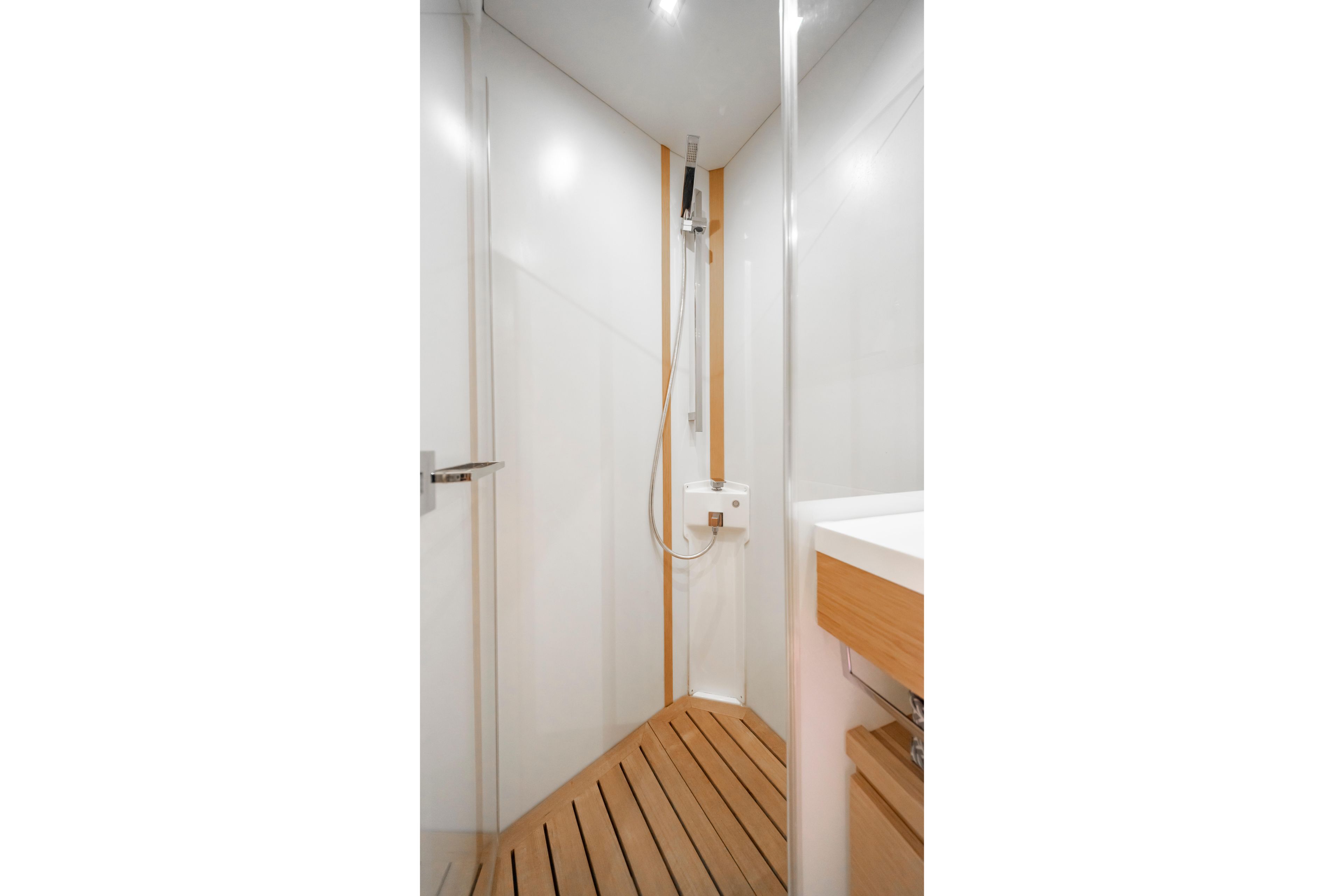 Modern shower area in 2016 Grand Soleil 58 yacht with wooden flooring.