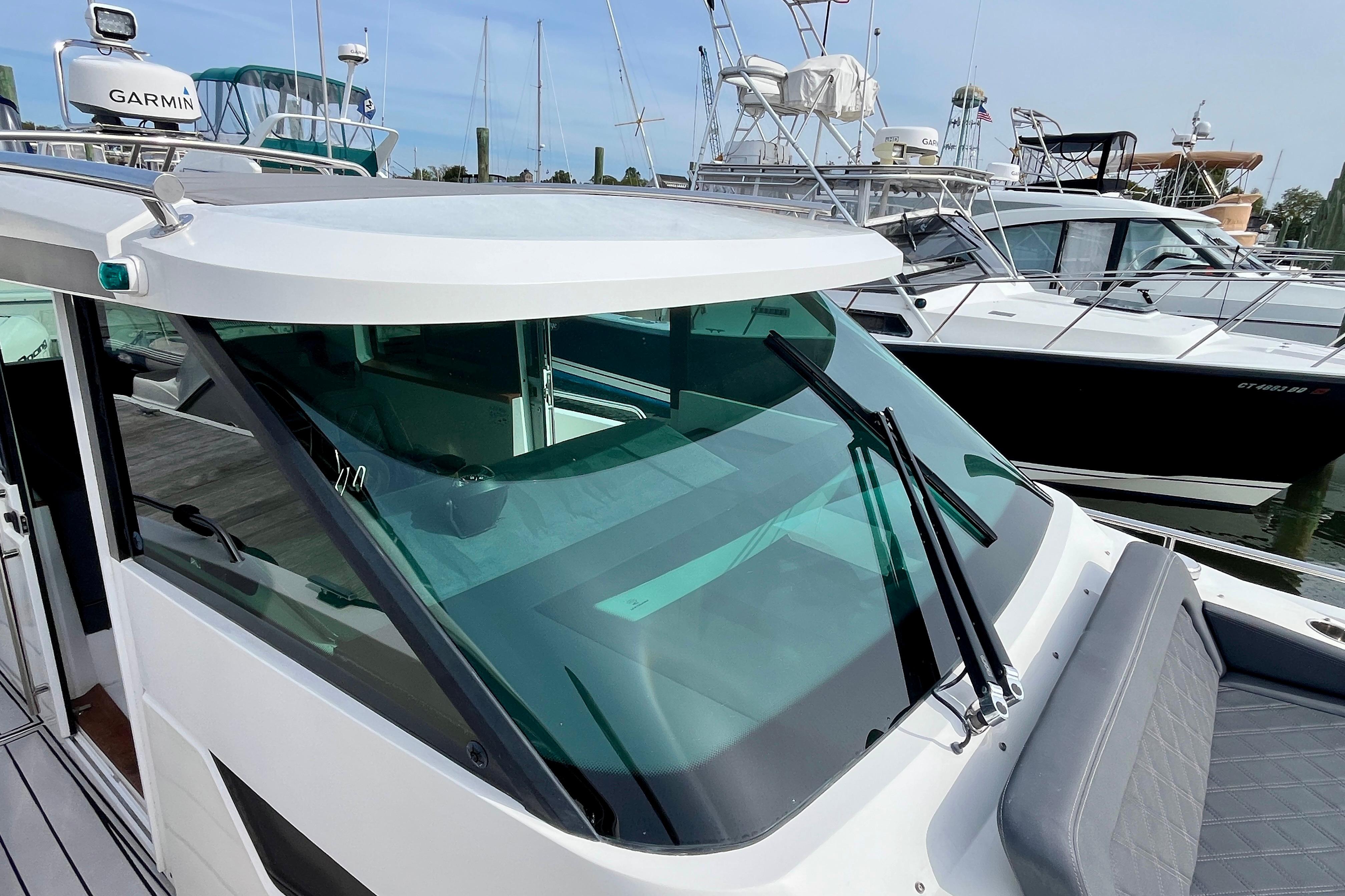 2018 Axopar 37 Sport Cabin R boat docked with sleek design and windshield wipers.
