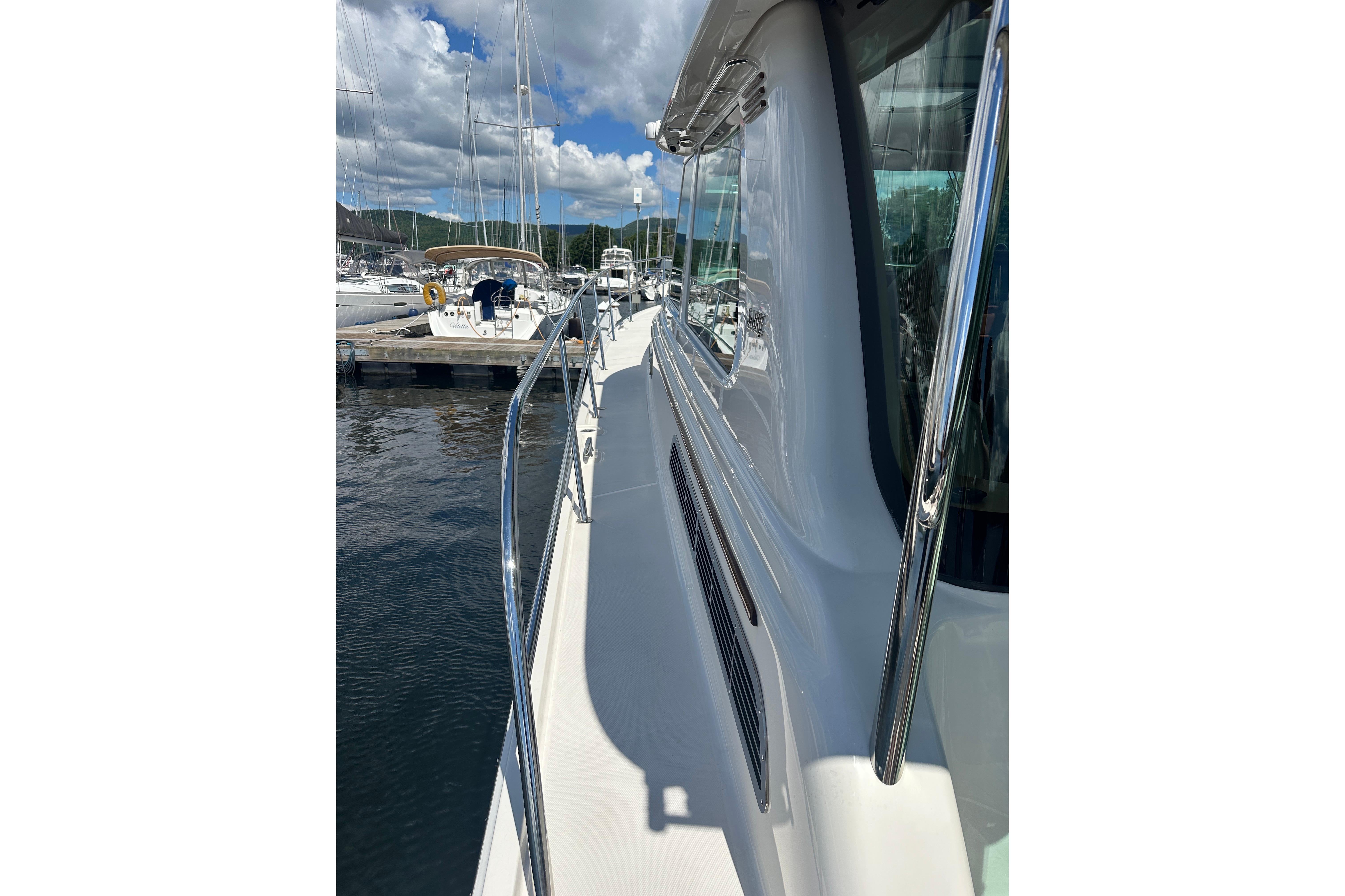 2025 Sabre 48 Salon Express yacht docked, showcasing sleek design and polished railings.
