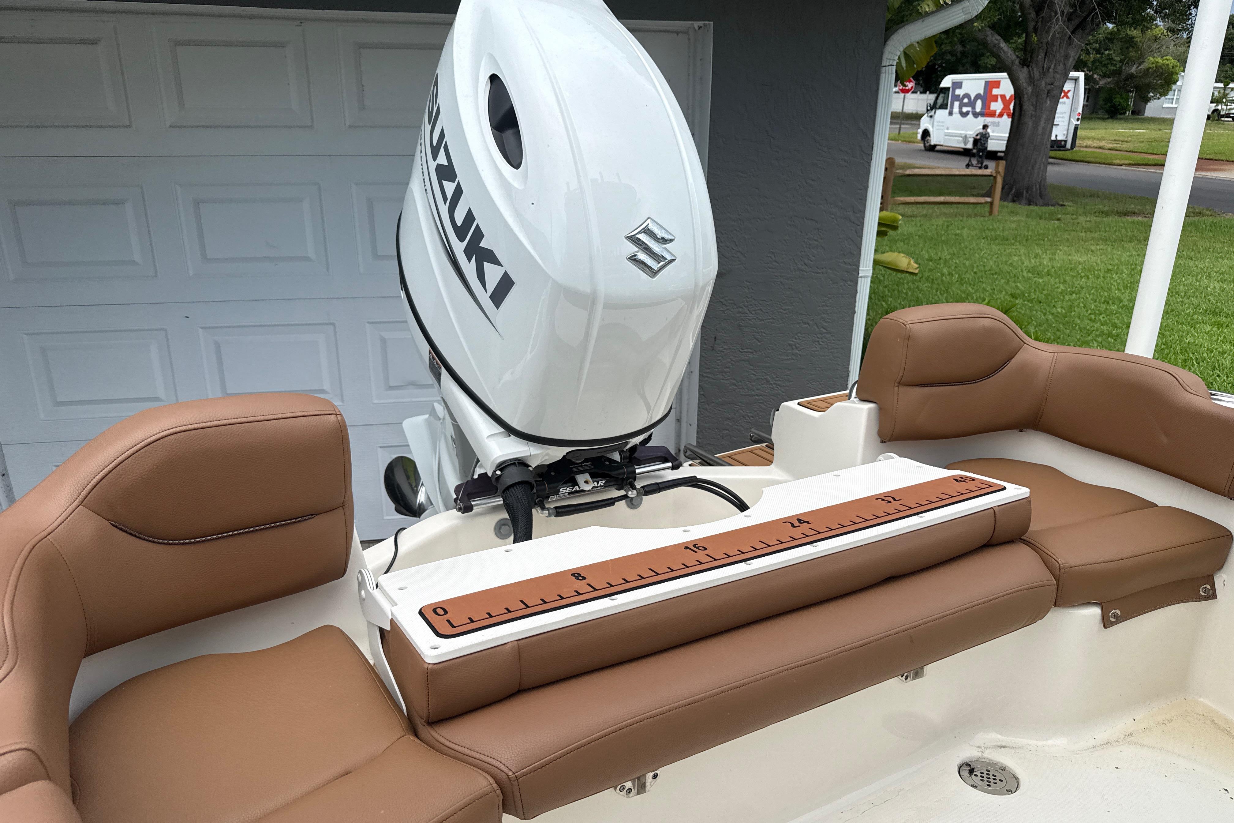 2023 Pioneer 202 Islander boat with Suzuki outboard motor and tan seating.