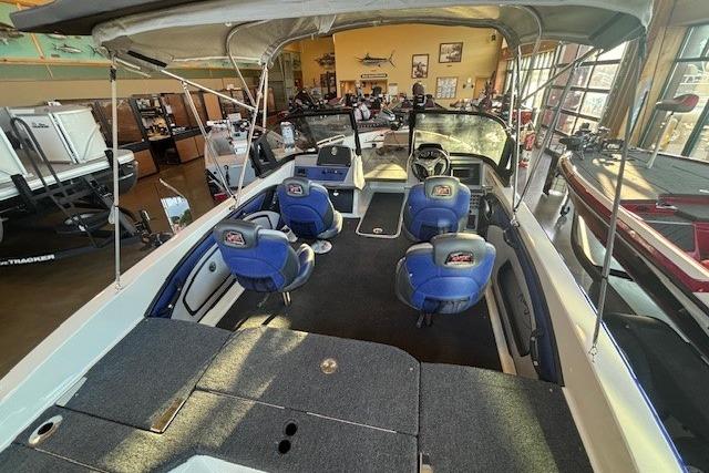 2026 Ranger 1850MS boat interior with blue seating and canopy in showroom.