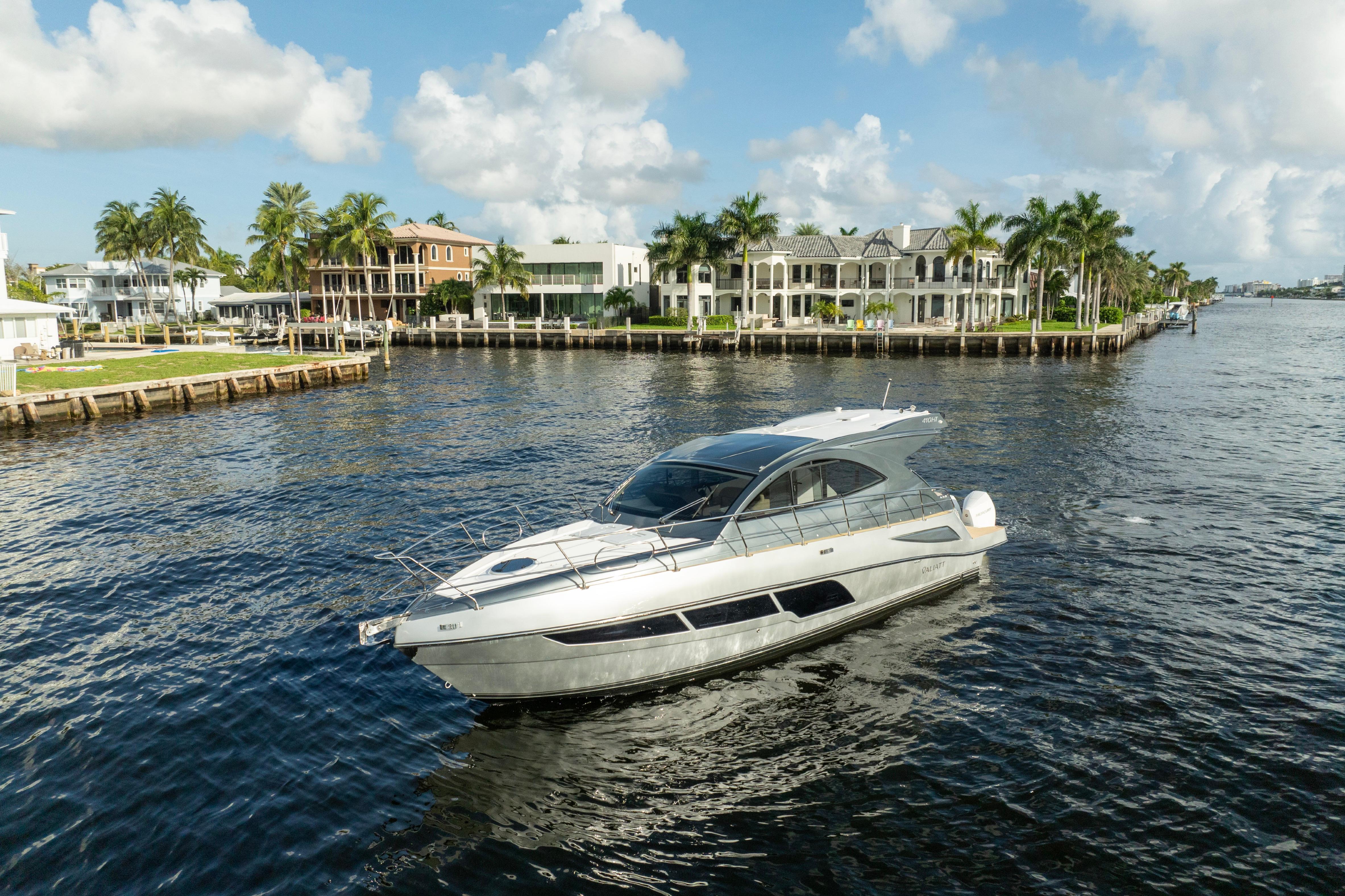 Luxury Valiatt 410HT yacht cruising near waterfront homes, 2025 model.