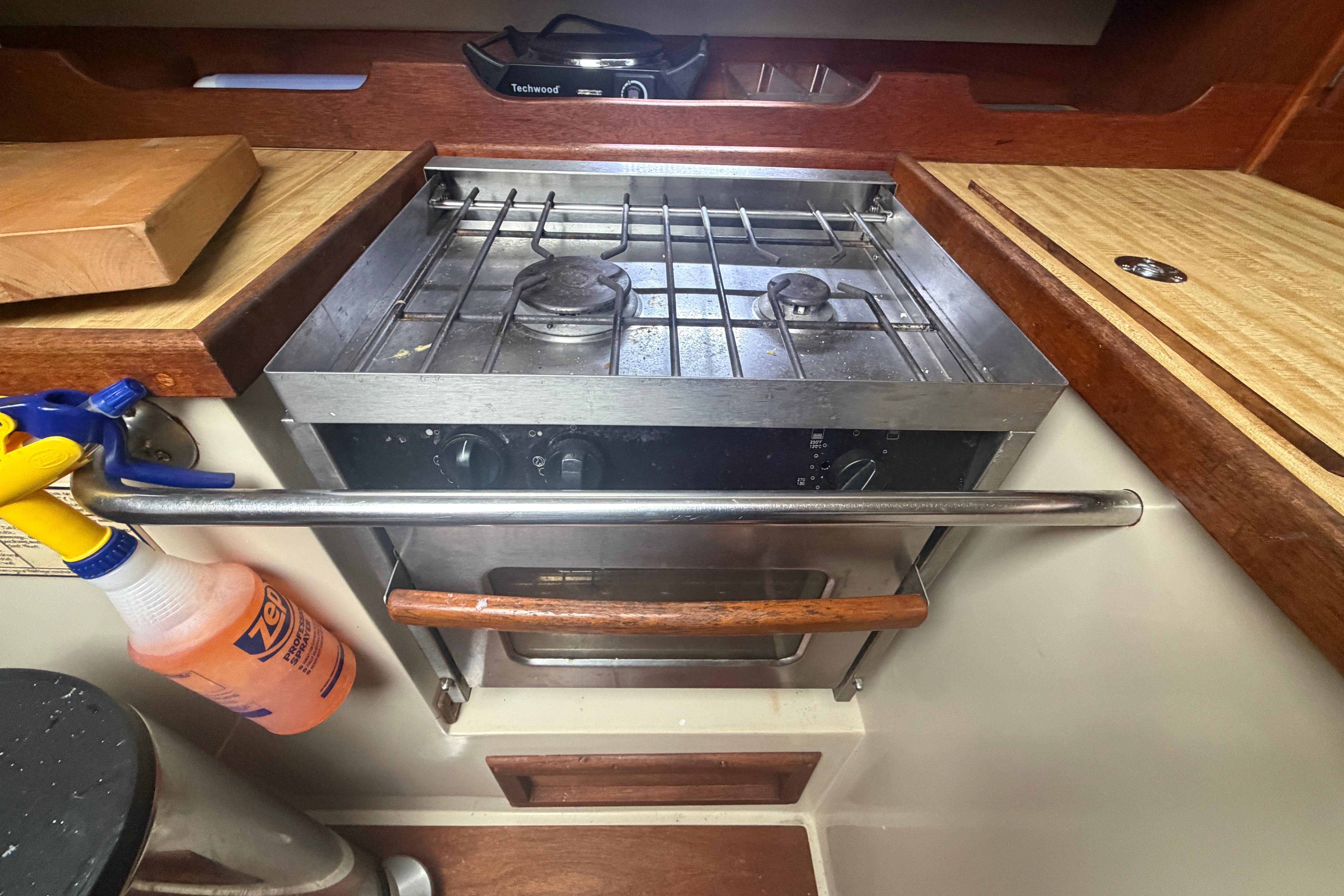1985 Catalina 36 yacht kitchen with stove and wooden countertops.