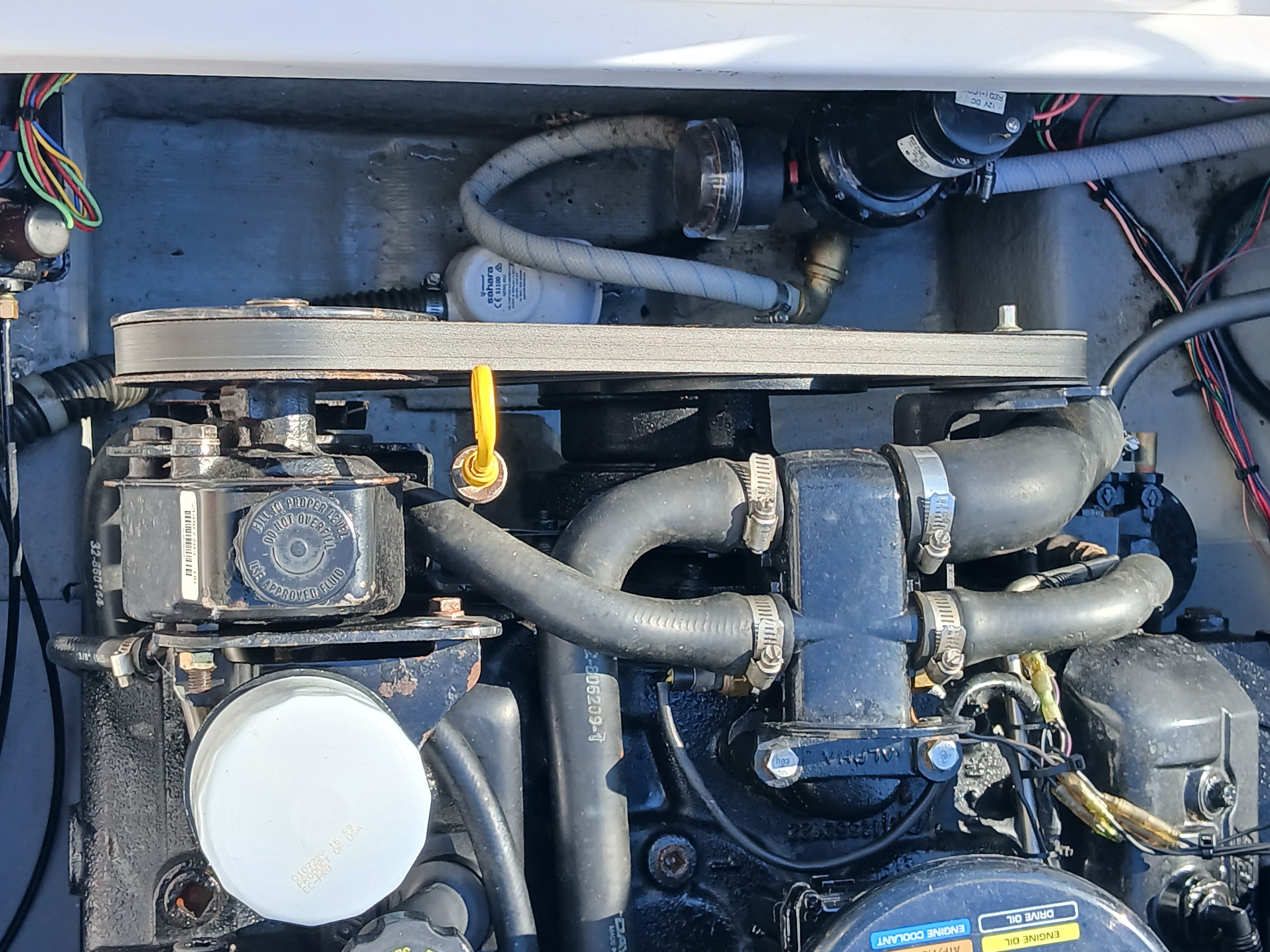 Close-up of a boat interior showing engine and hoses.