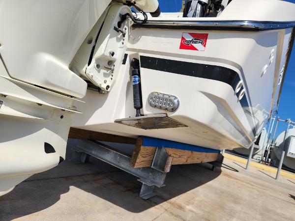 2005 Pursuit 3070 Offshore Center Console boat on trailer, rear view, showing motor and hull details.