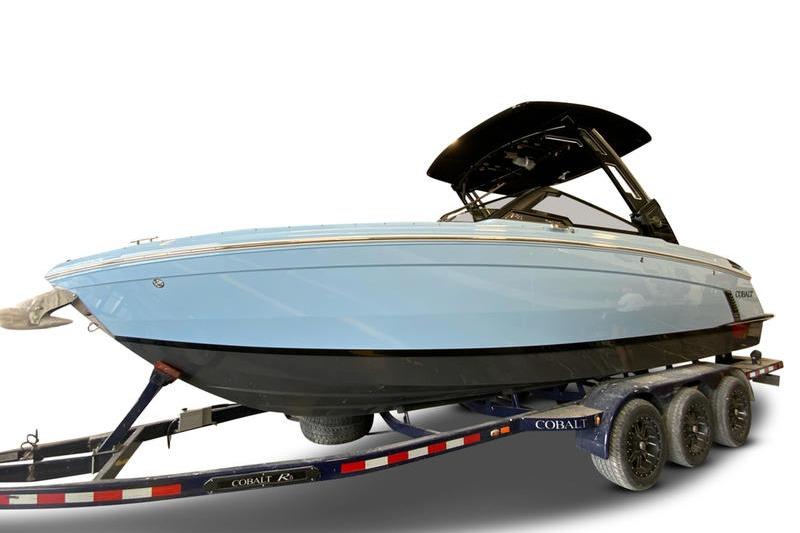2026 Cobalt R8 Surf boat on trailer, sleek design, light blue hull.