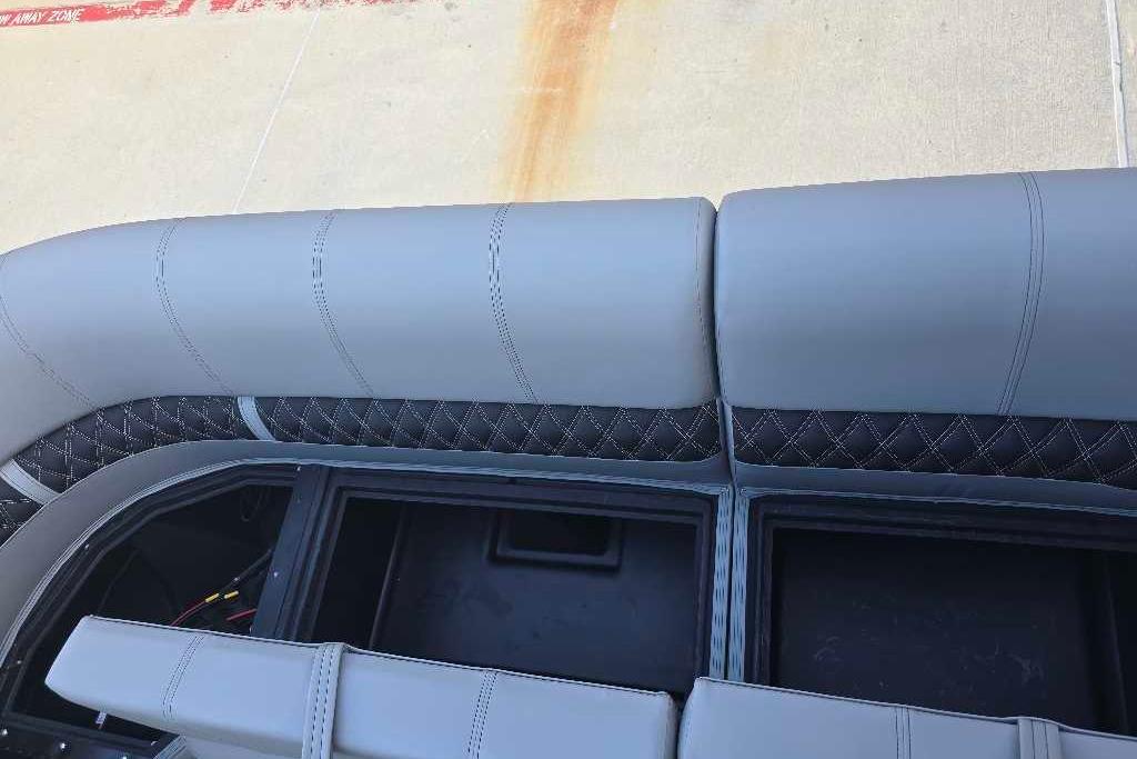 2026 Ranger 223FC boat seating with storage compartments, featuring gray upholstery and diamond stitching.