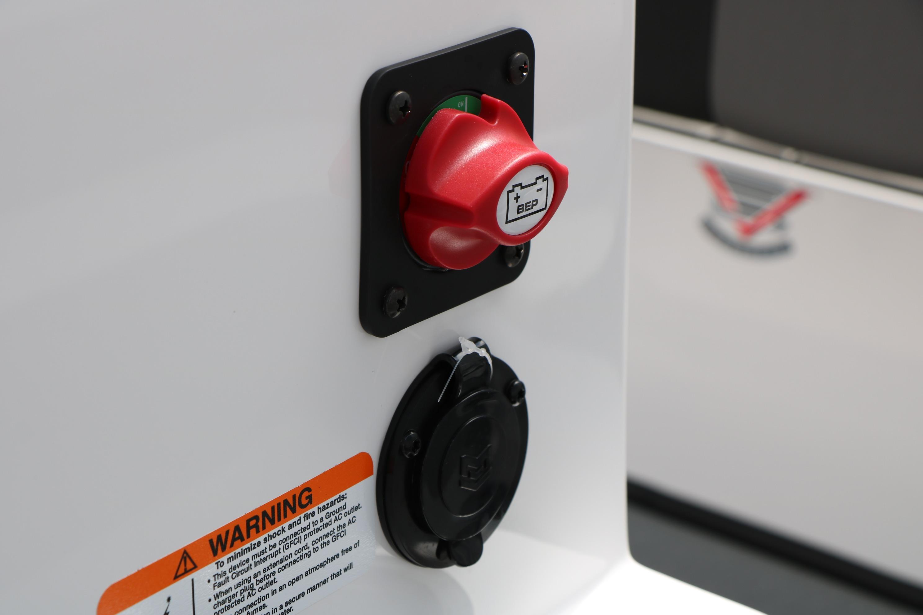 Close-up of a 2026 Vexus Defender 201 battery switch and warning label.