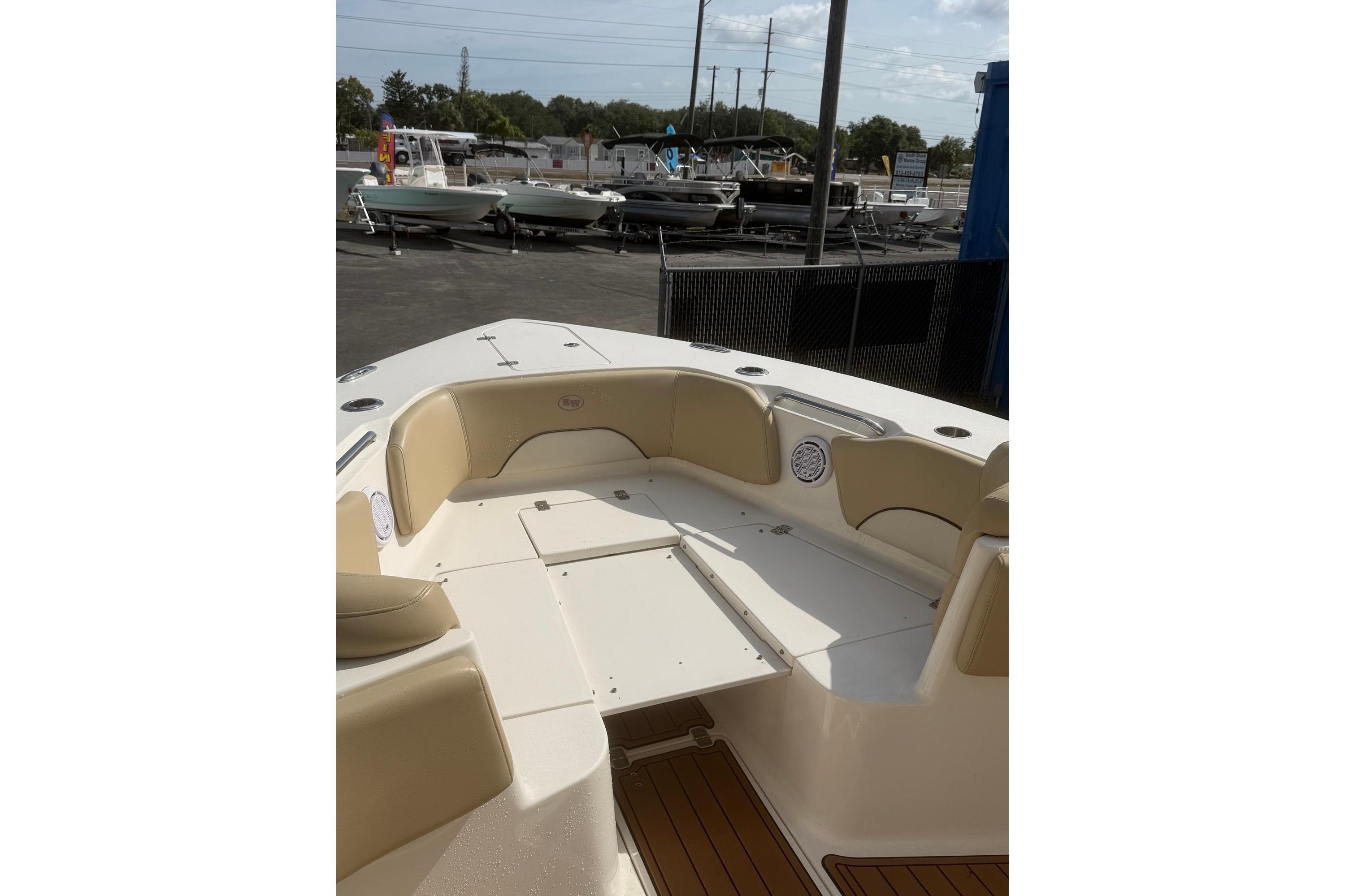 2019 Key West 263 FS boat interior with beige seating and deck view.