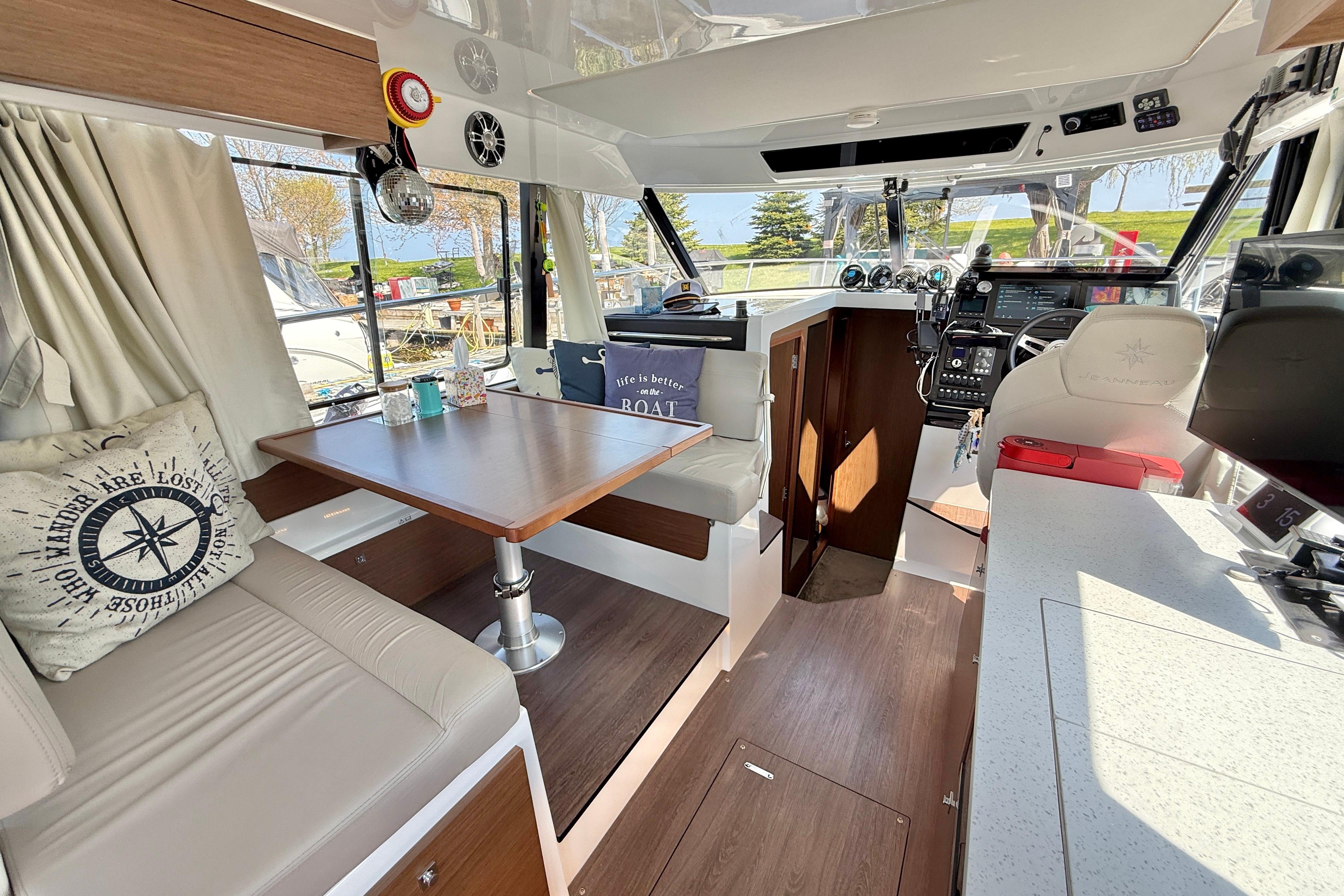 Interior of 2022 Jeanneau NC 1095 Fly boat with modern seating and navigation area.