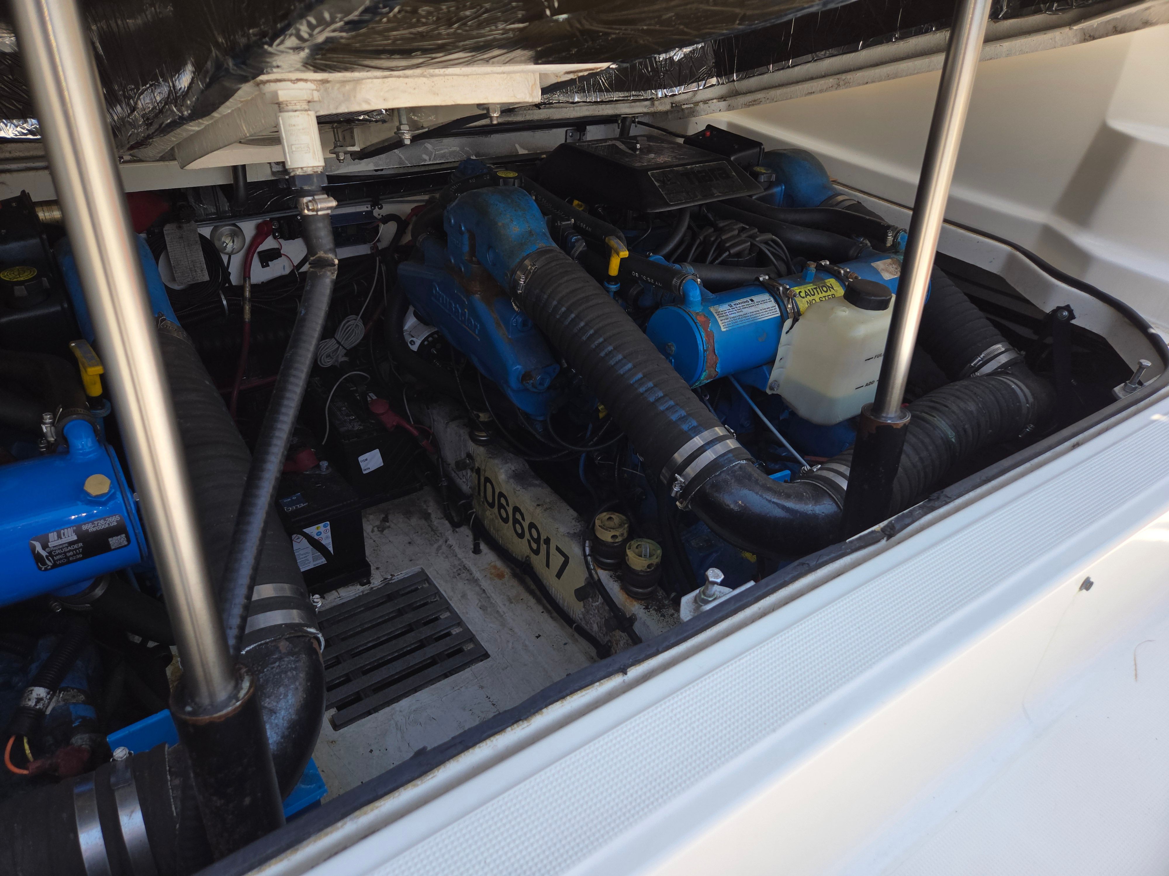 Engine compartment of a 1997 Tiara Yachts Open with blue engines.