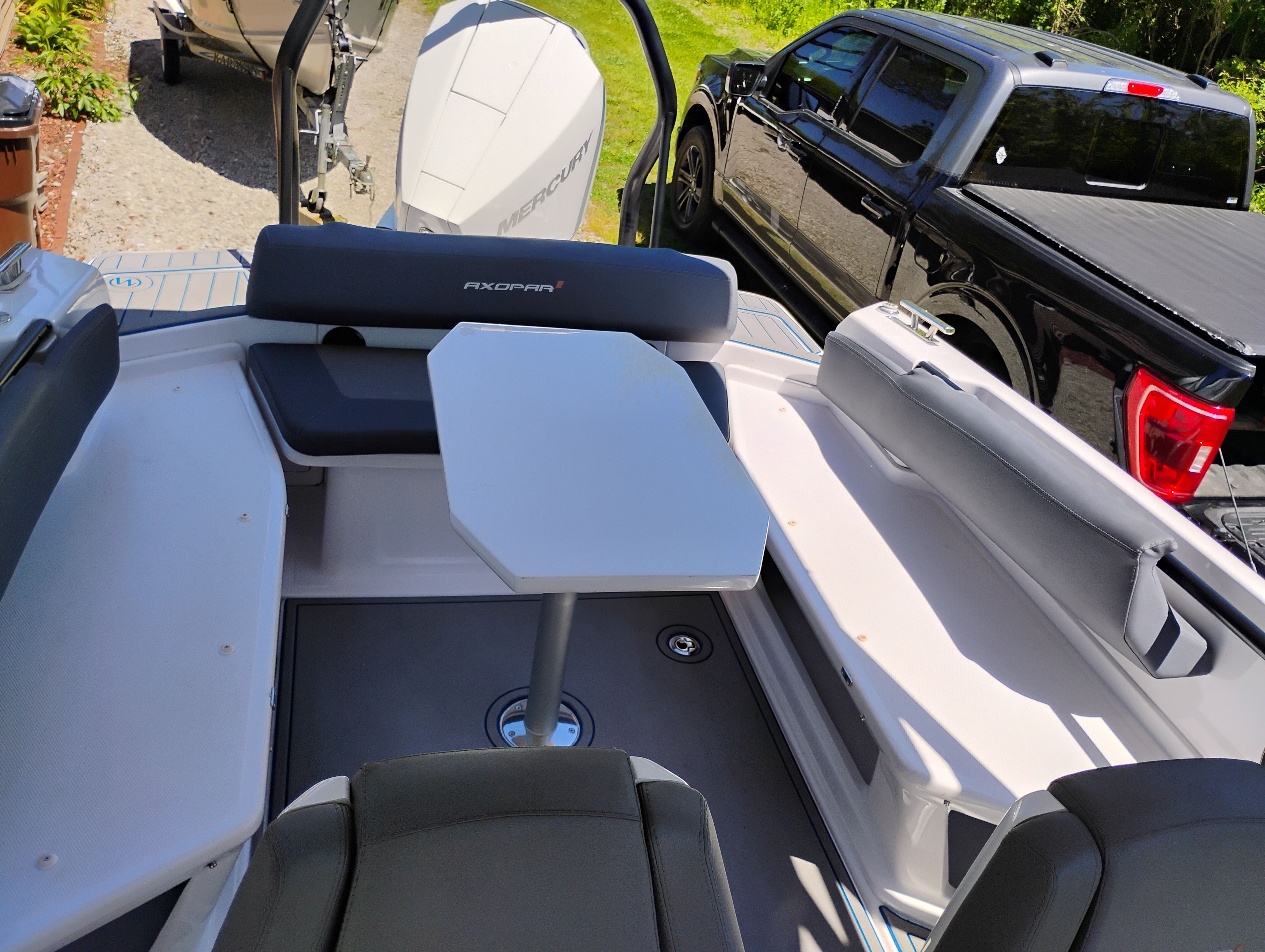 Interior of 2022 Axopar 22 T-Top with seating and table.