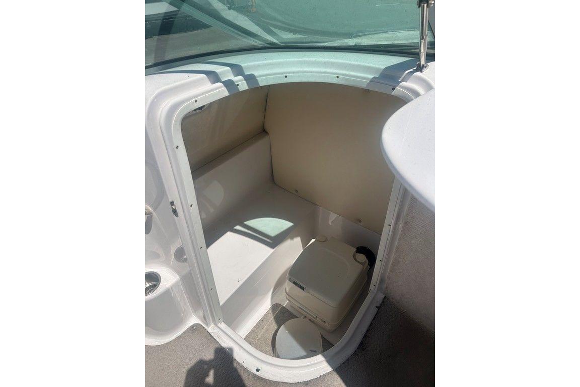 2006 Four Winns 244 Funship boat interior with compact restroom area.