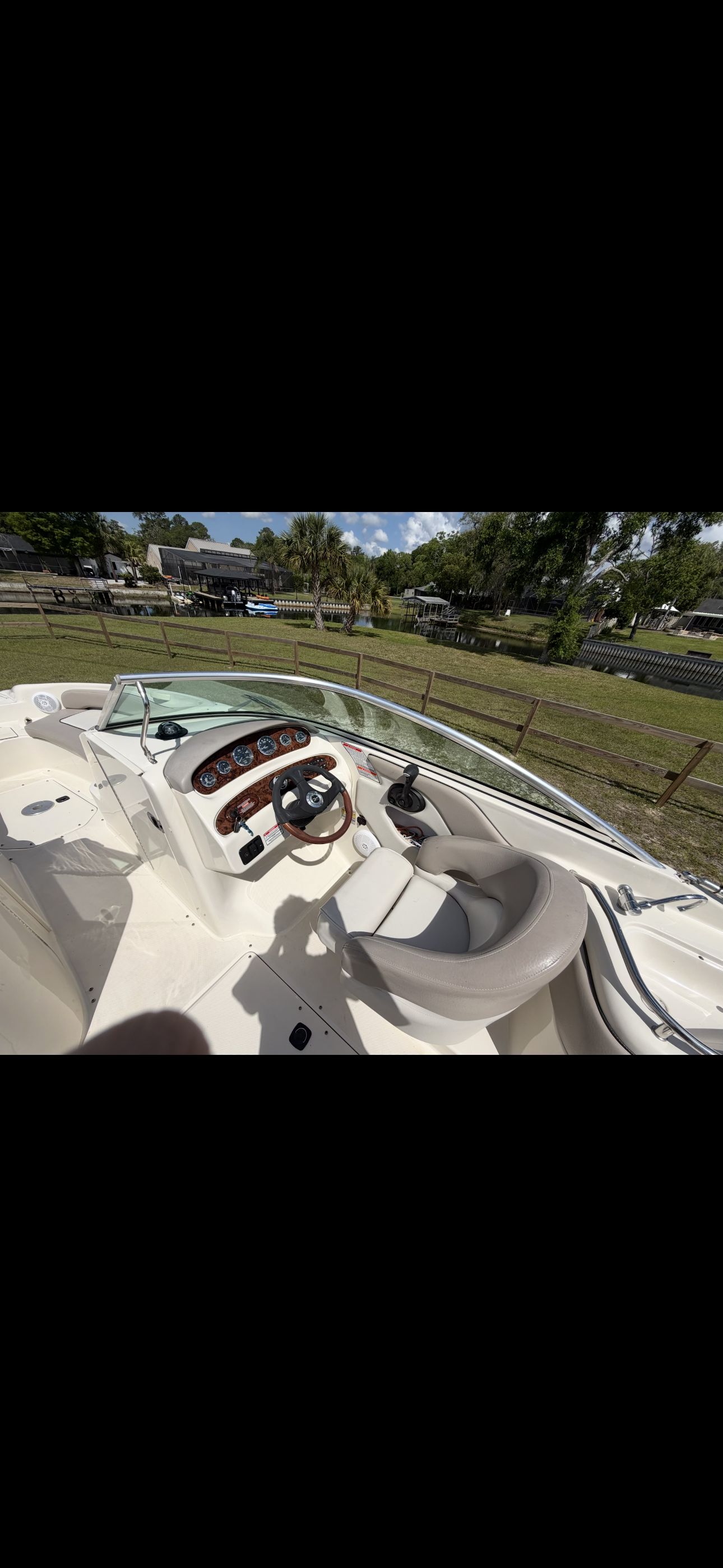 Interior view of a Sea Ray Bowrider with steering wheel and dashboard.