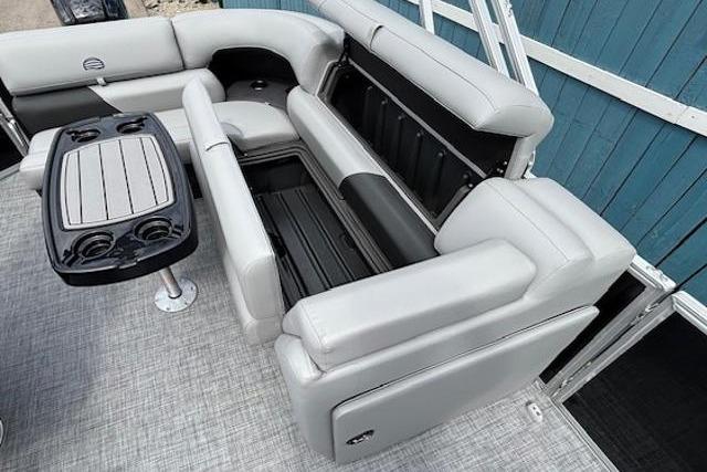 2026 Sun Tracker Party Barge 20 DLX interior with gray seating and table.