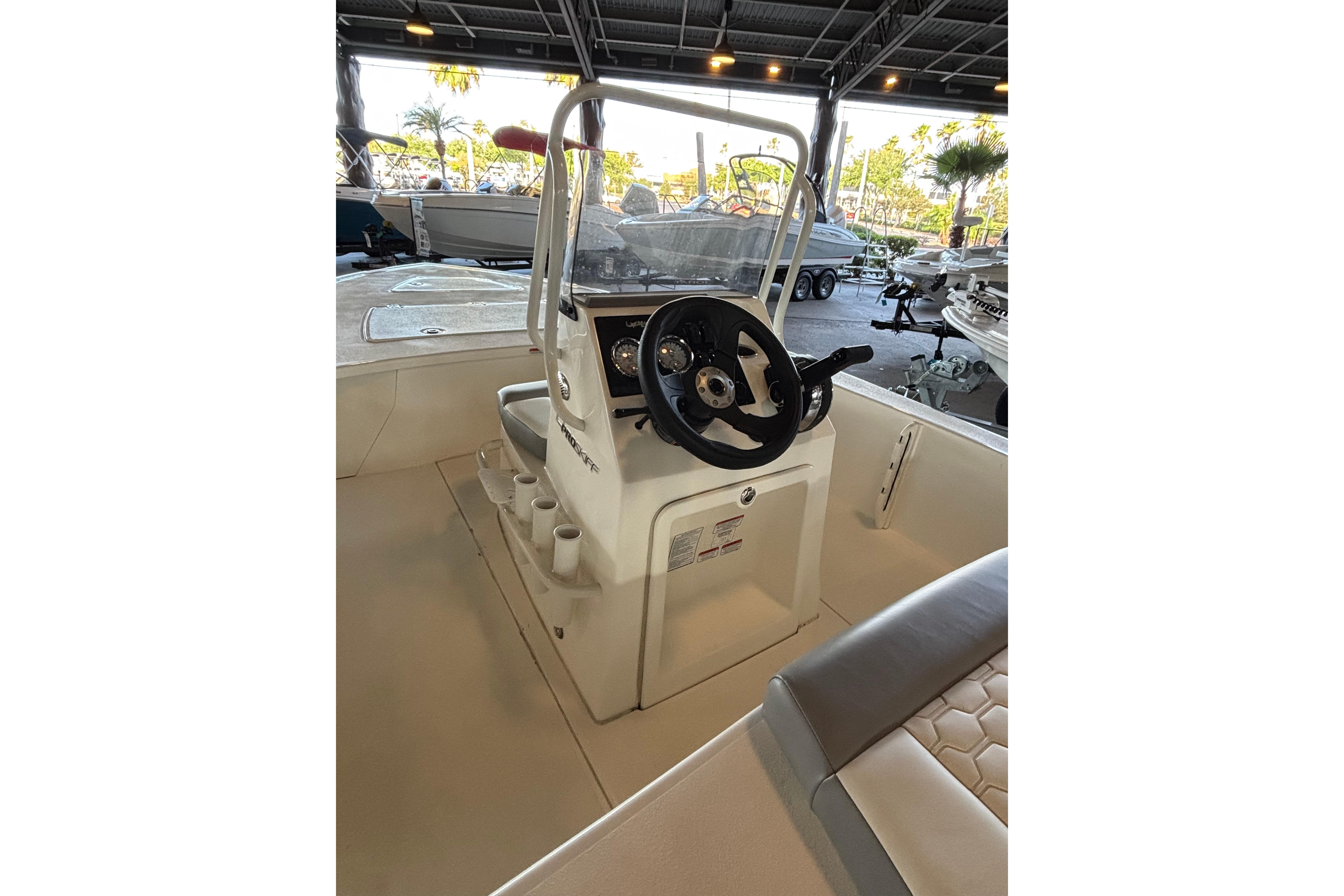 2026 Mako 18 Pro Skiff boat interior with steering console and seating.