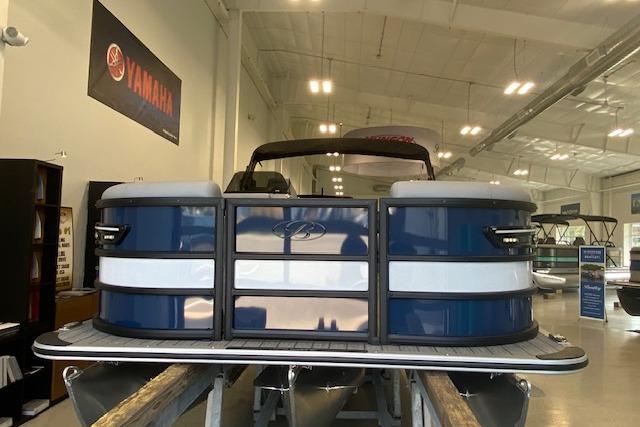 2026 Bentley Pontoons Elite 223 Swingback in showroom, blue and white exterior.