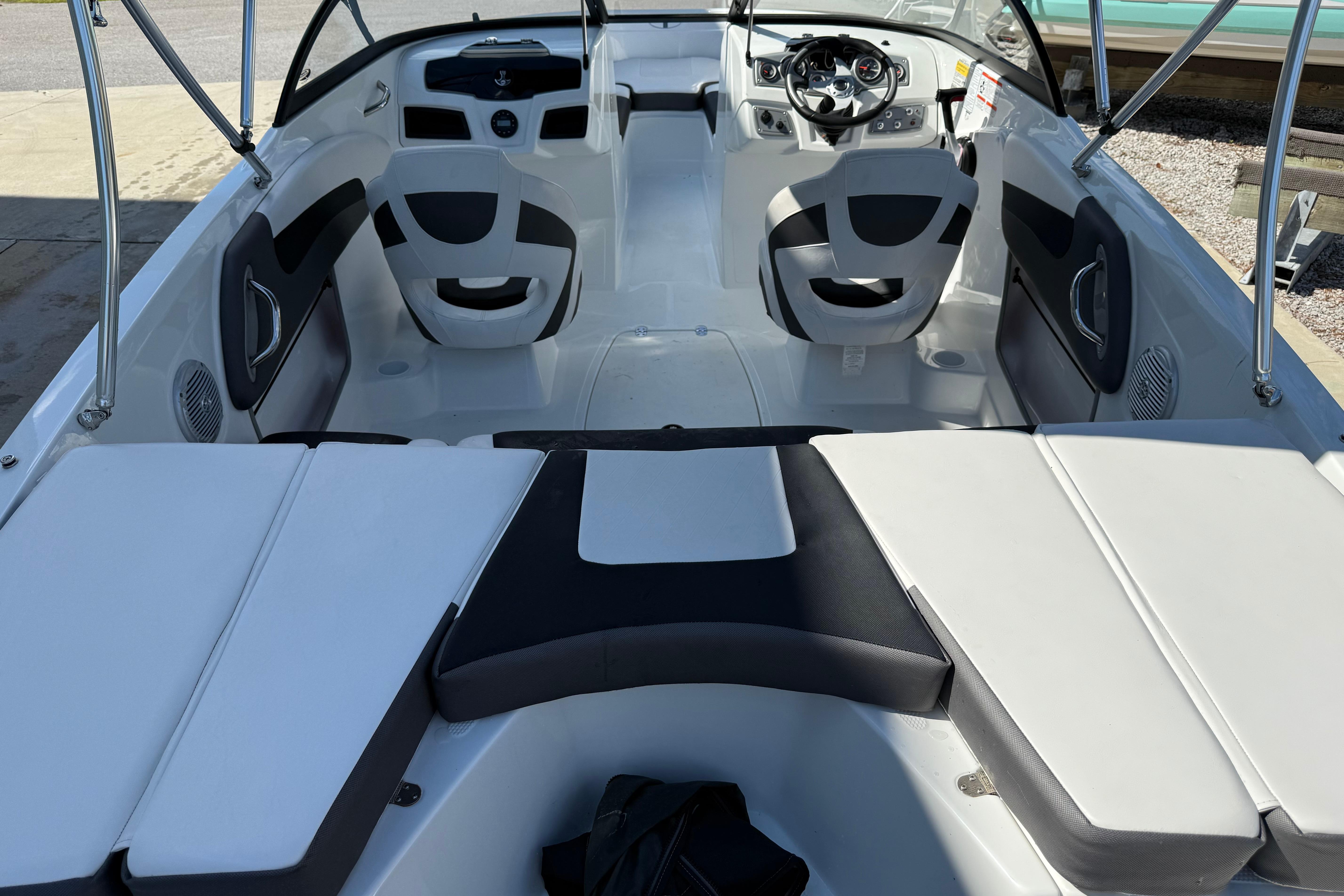 2021 Tahoe 550 TS boat interior with seating and steering wheel, showcasing modern design.
